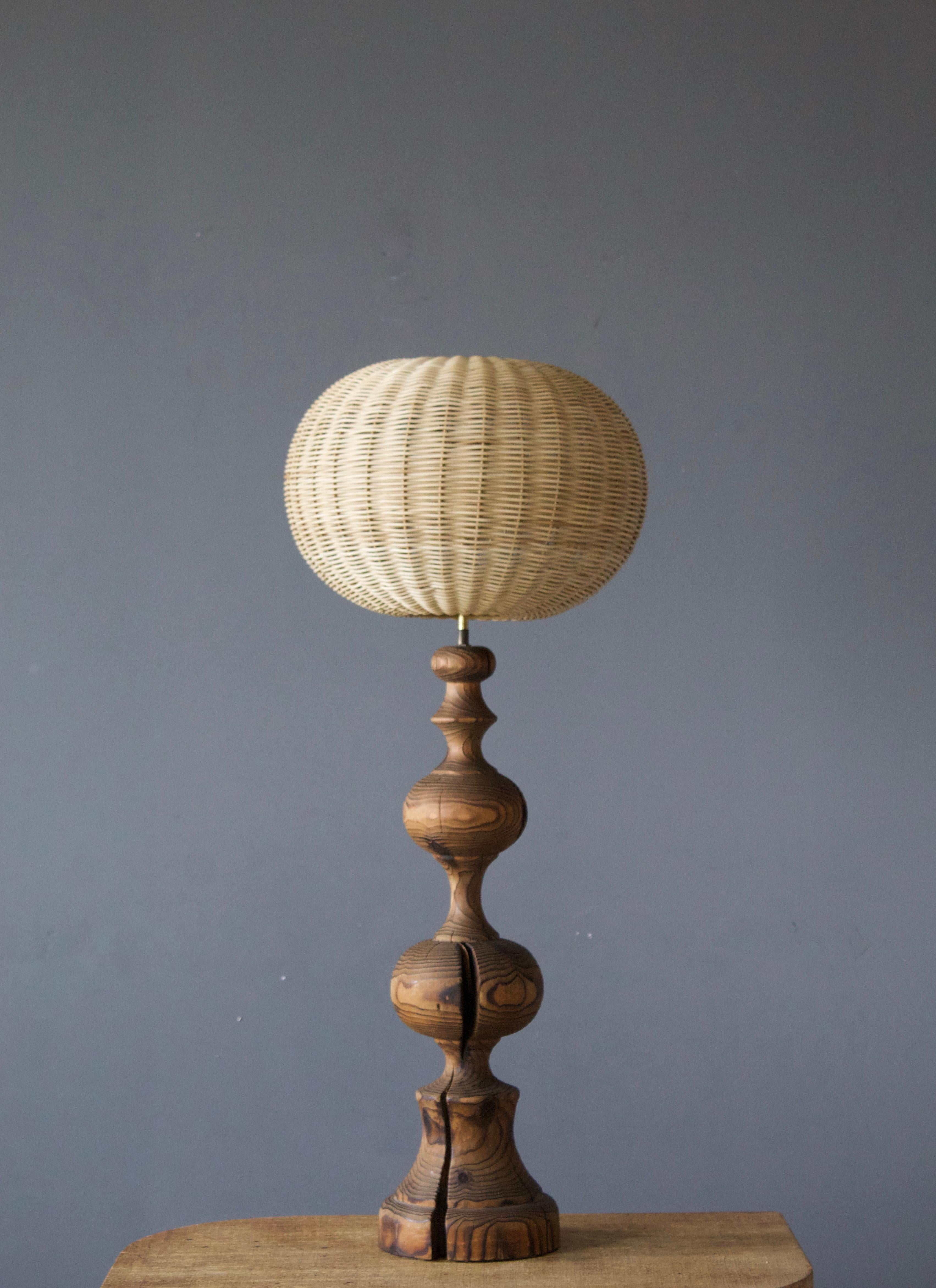 A table lamp, produced in Italy, 1970s. Finely turned solid pine.

Stated dimensions exclude lampshade, height includes socket. Illustrated model rattan lampshade can be included in purchase upon request.

Other designers of the period include