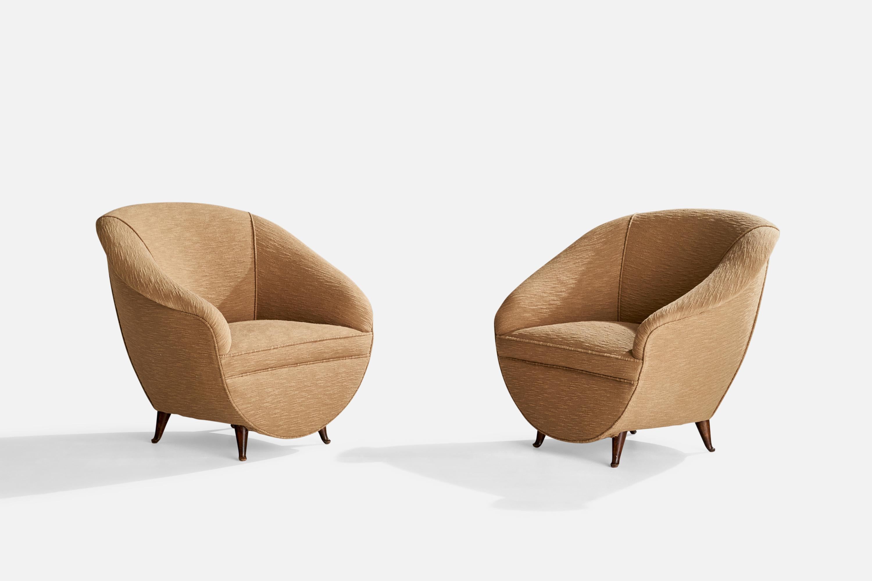 A pair of beige fabric and walnut lounge chairs designed and produced in Italy, 1940s.

Seat height: 15.5”