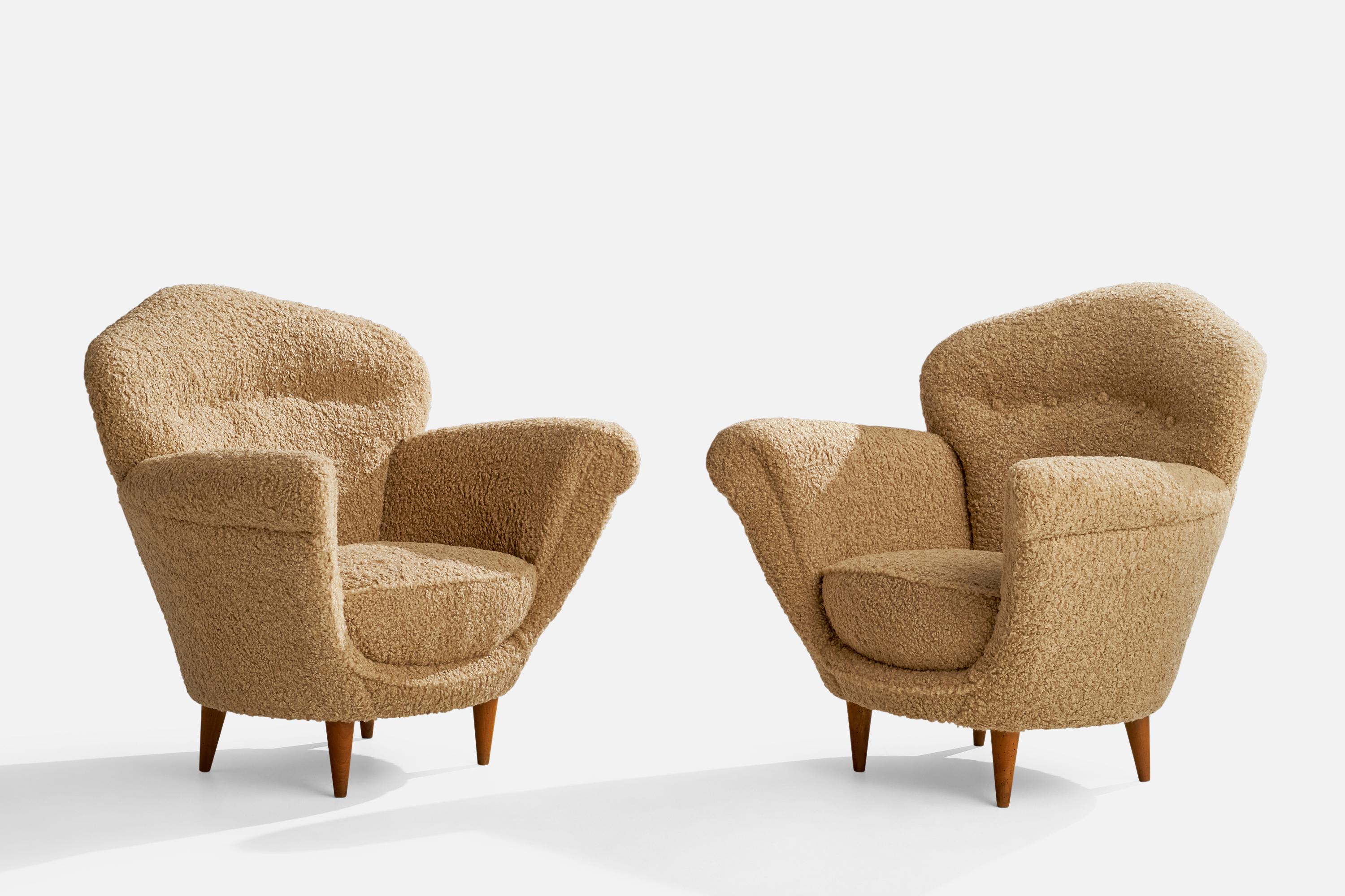 A pair of wood and beige bouclé fabric lounge chairs designed and produced in Italy, 1940s.

Seat height 15.5”