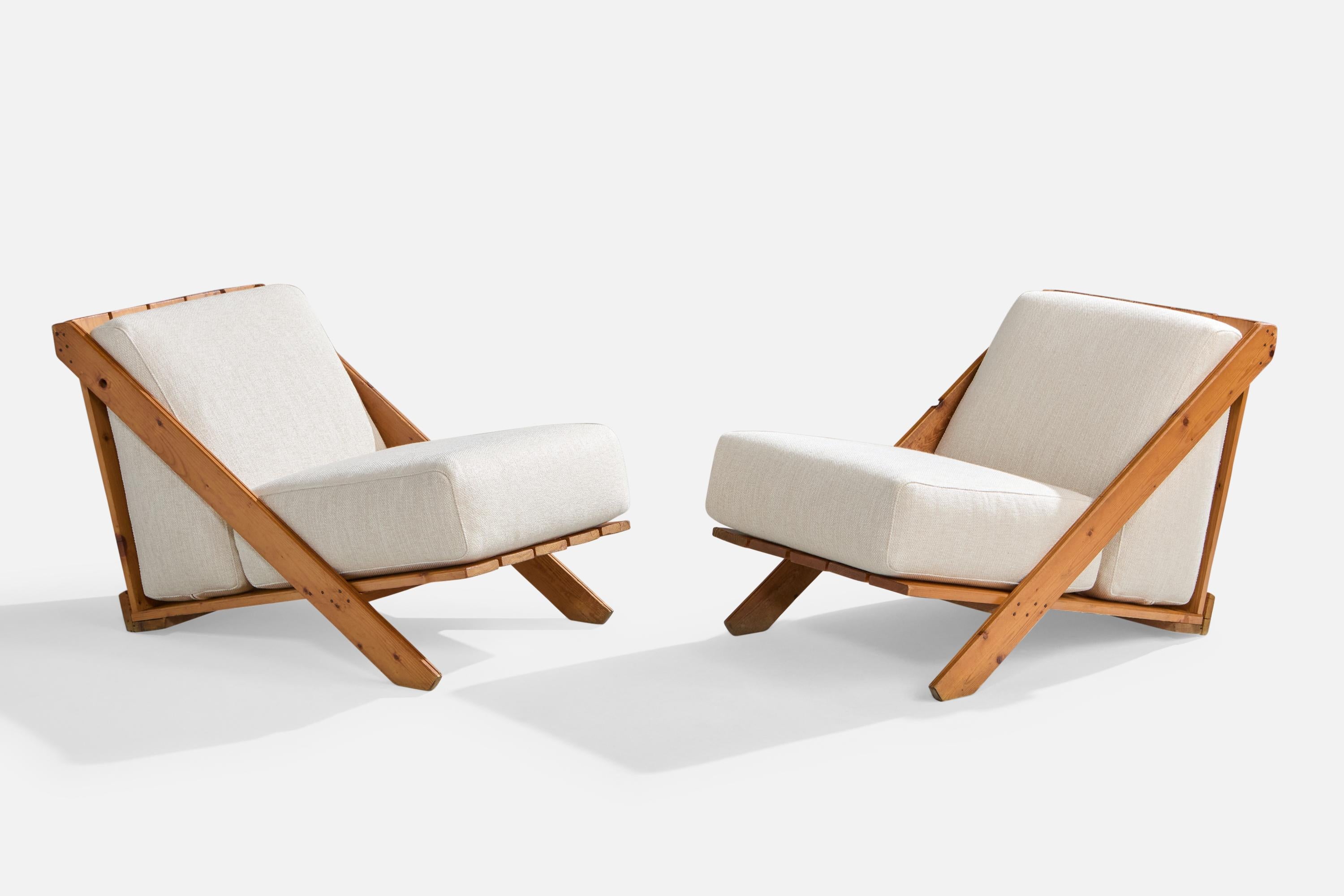 A pair of pine and white fabric lounge chairs designed and produced in Italy, c. 1970s.

Reupholstered in brand new fabric.

Overall Dimensions (inches): 23.75” H x 22.675” W x 36” D

Seat Height (inches): 16”

All upholstered furniture can be