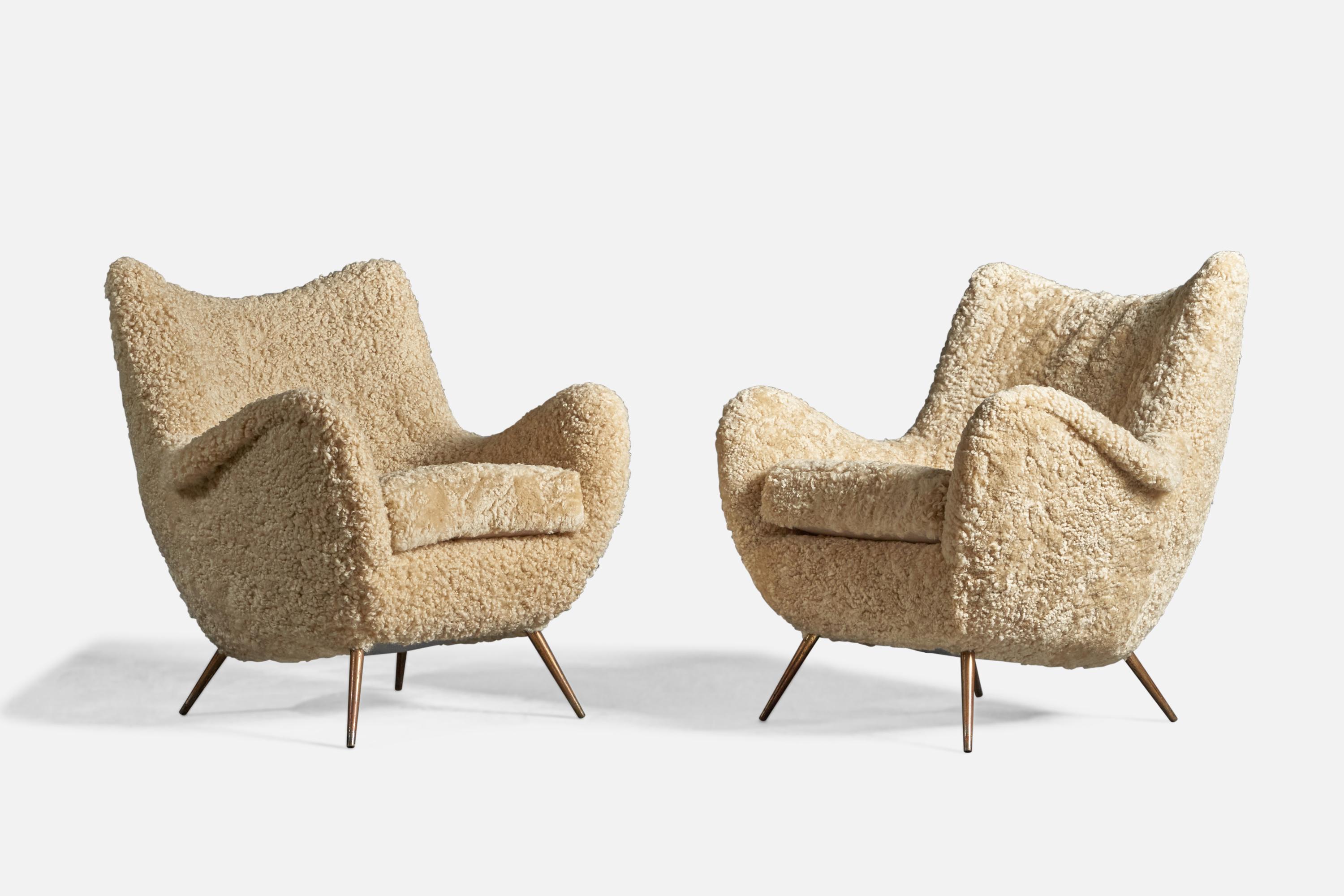 A pair of beige shearling and brass lounge chairs, designed and produced in Italy, 1950s

18
