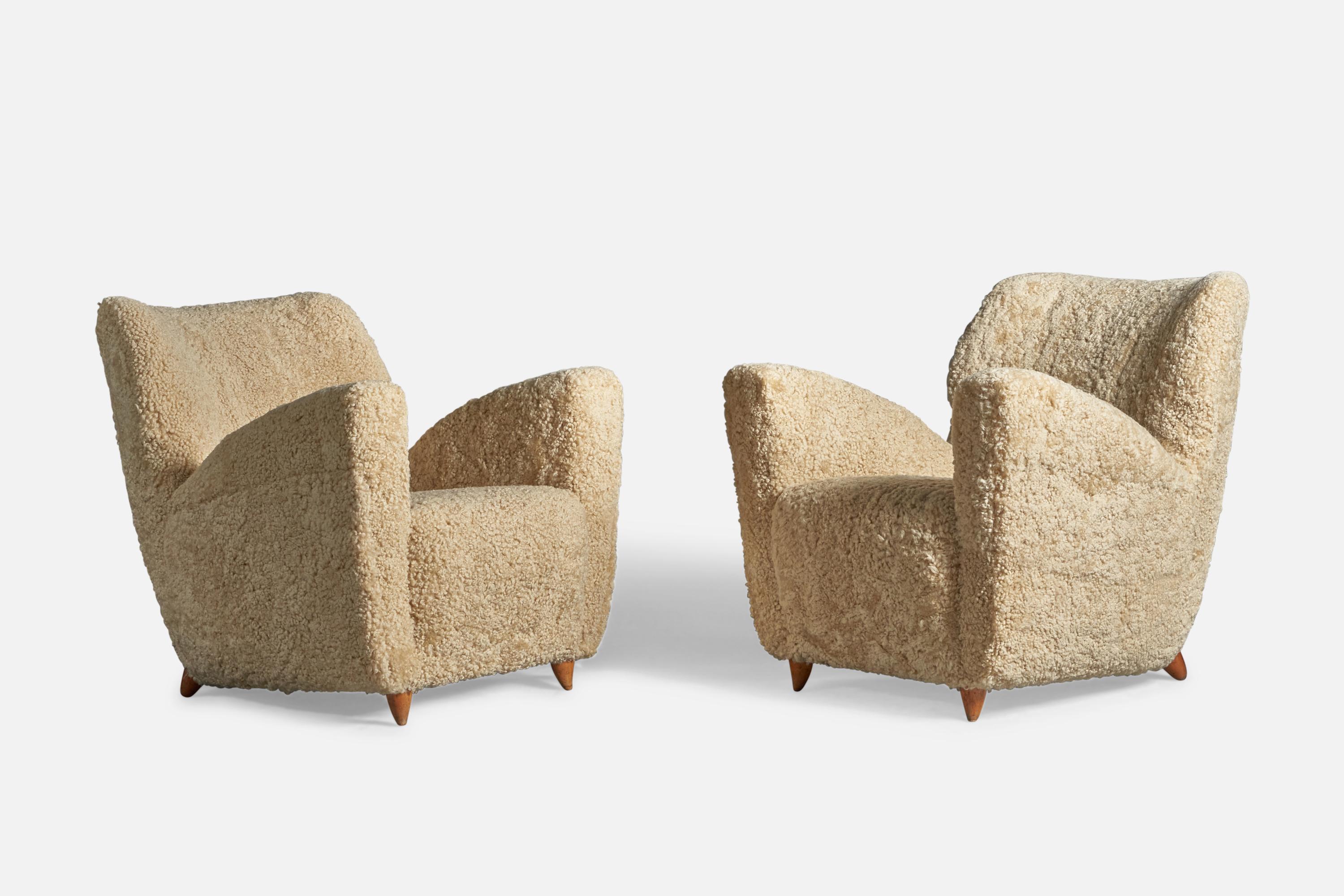 A pair of organic wood and beige shearling lounge chairs, designed and produced in Italy, 1940s.
