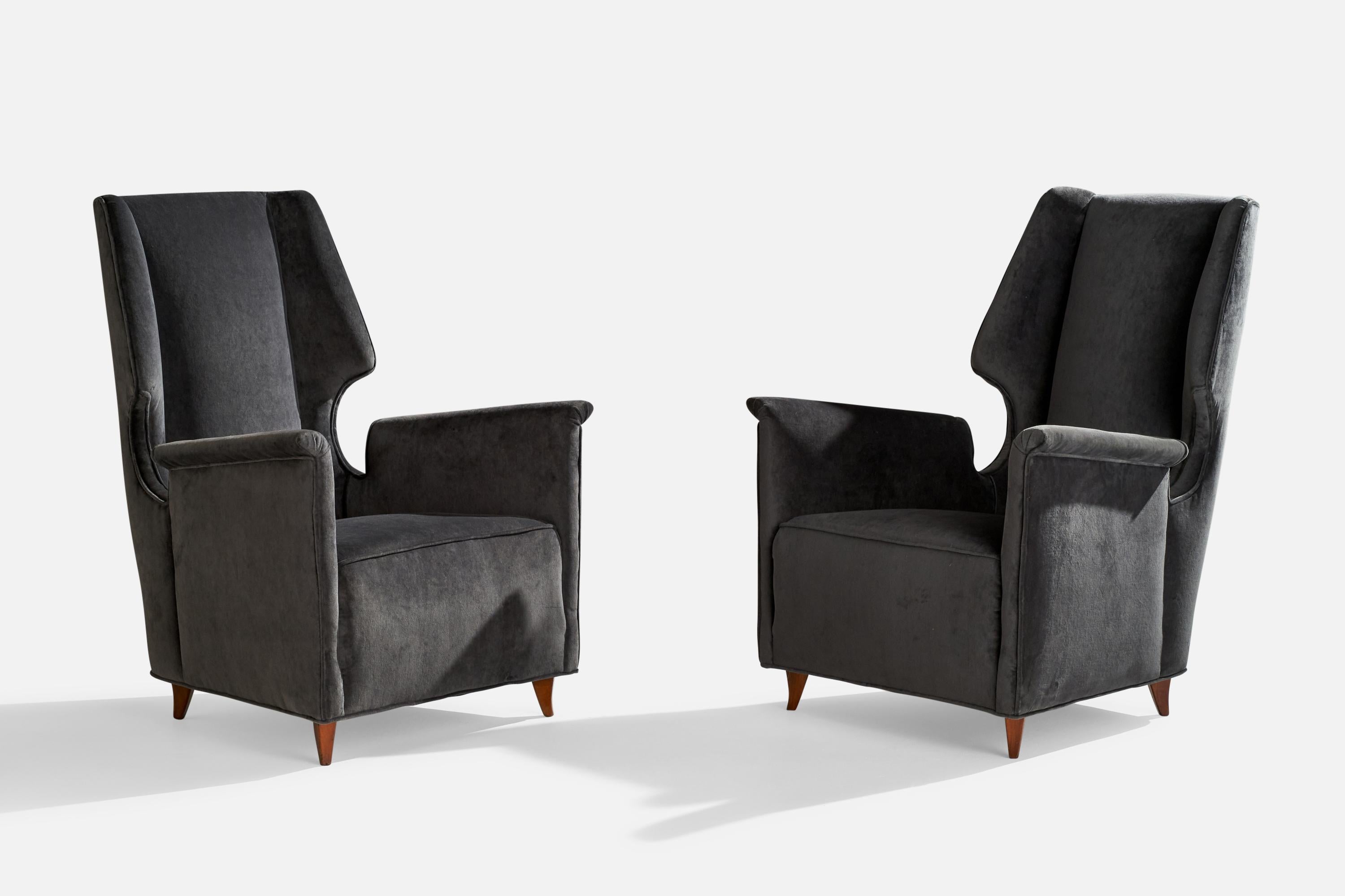 A pair of wood and dark grey velvet lounge chairs designed and produced in Italy, 1950s.

seat height 15.56” 