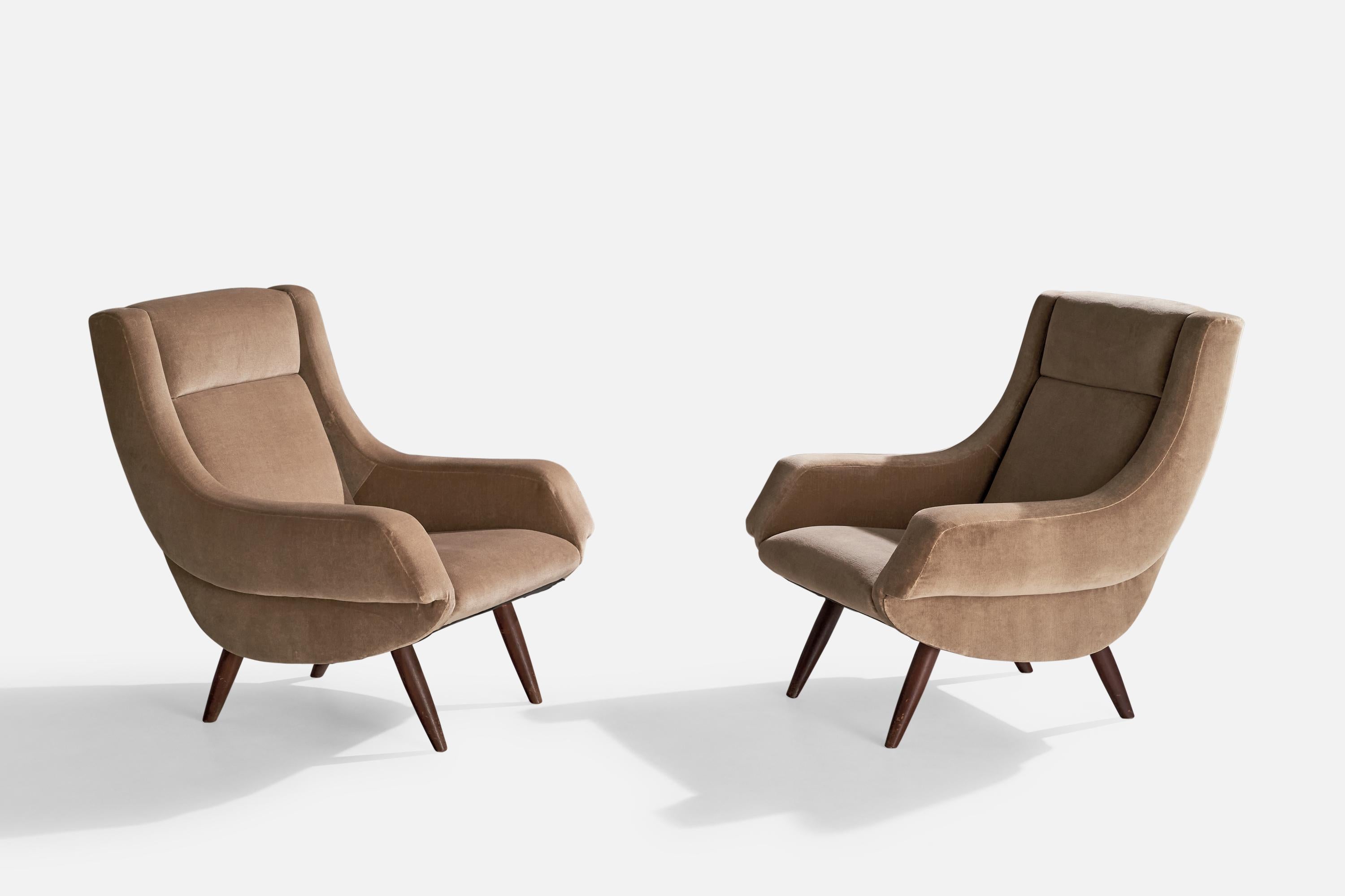 A pair of dark-stained wood and brown beige velvet lounge chairs designed and produced in Italy, c. 1950s.

Dimensions: 34.75” x 29.25” W x 30” D

Seat height: 15”