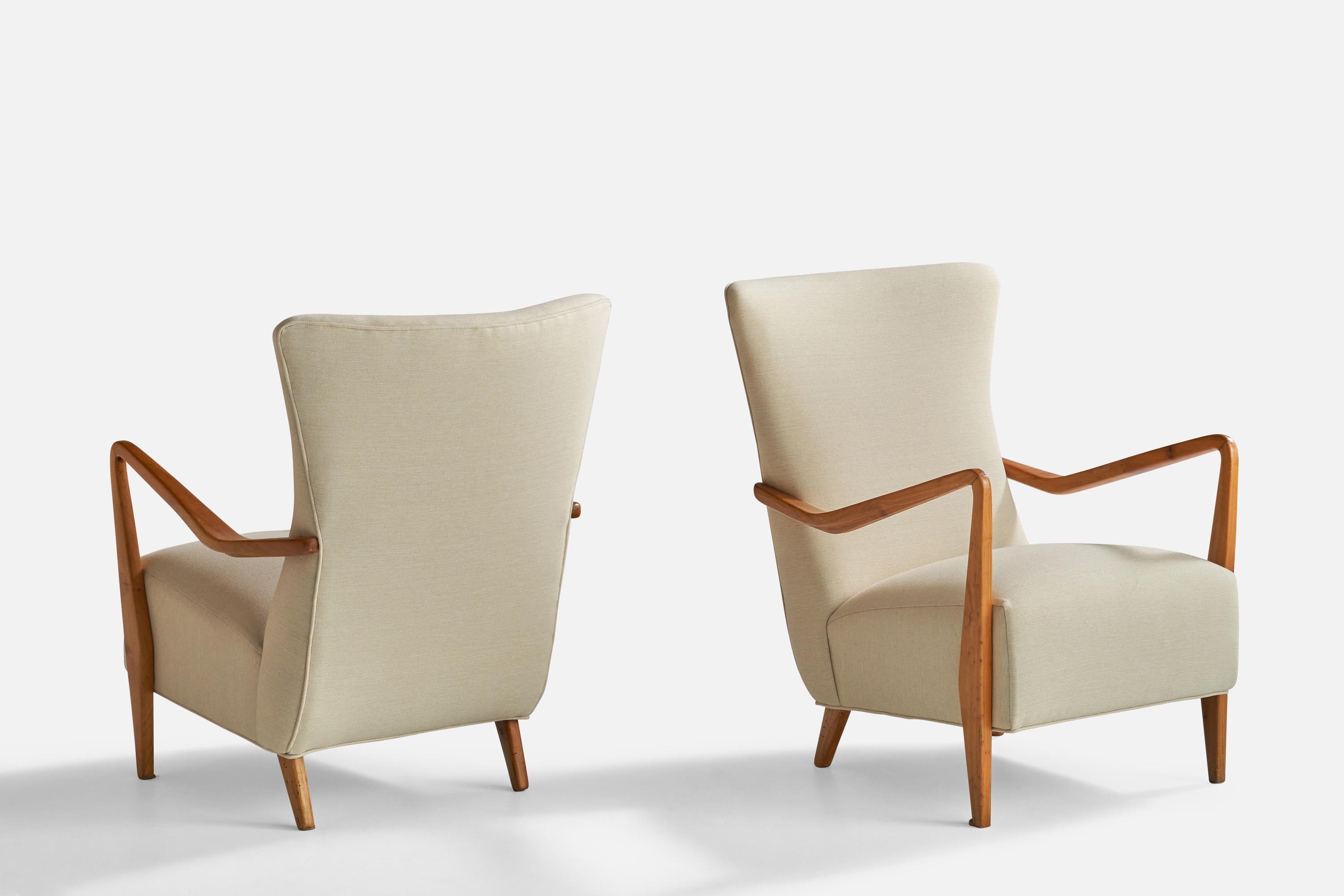 A pair of walnut and white fabric lounge chairs designed and produced in Italy, 1950s.

Seat height 15