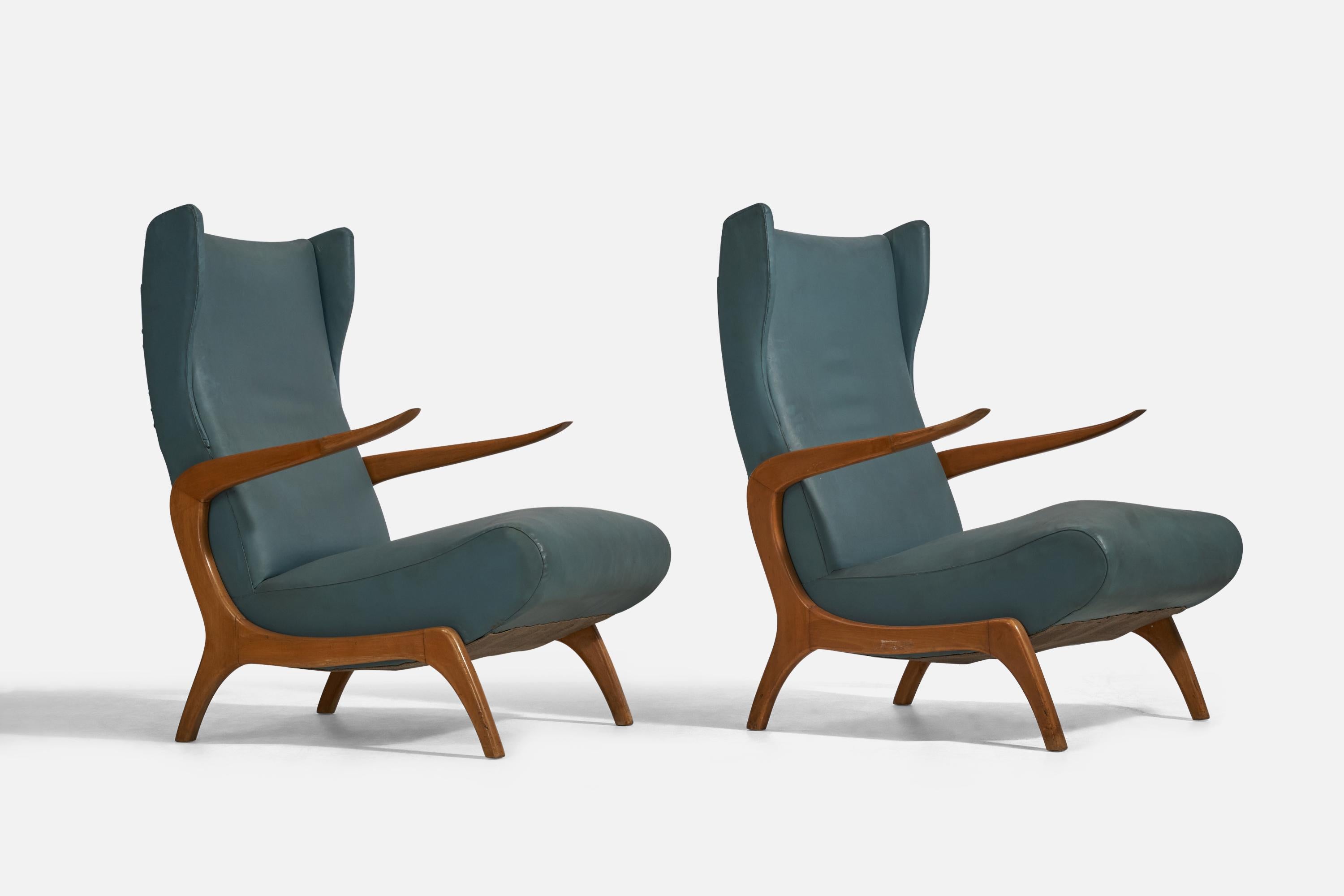 A pair of blue vinyl and wood lounge chairs designed and produced in Italy, 1950s.