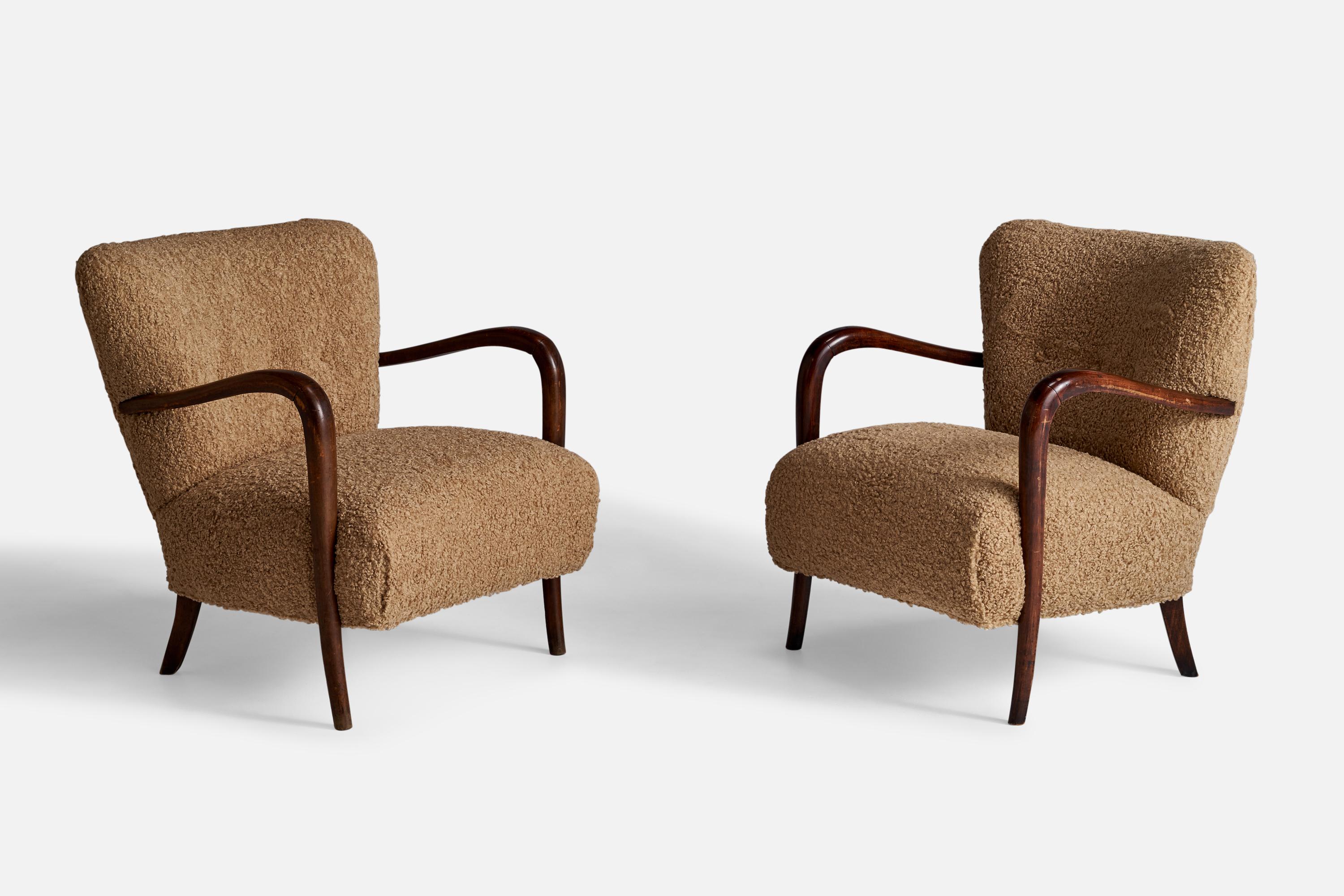 A pair of dark-stained wood and beige bouclé fabric lounge chairs designed and produced in Italy, 1940s.

Seat height: 15.5”