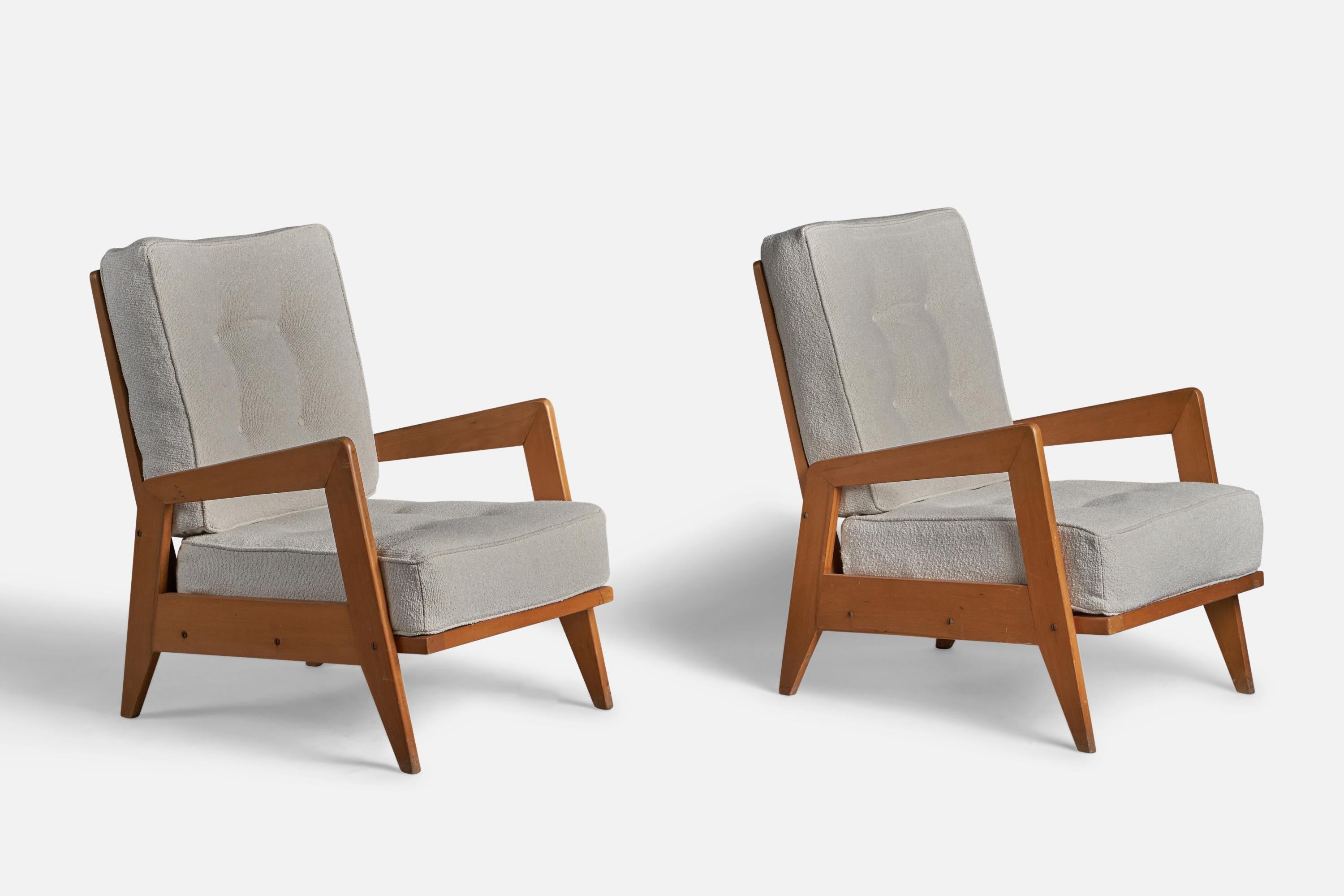 A pair of off-white fabric and wood lounge chairs, designed and produced in Italy, 1950s.

14