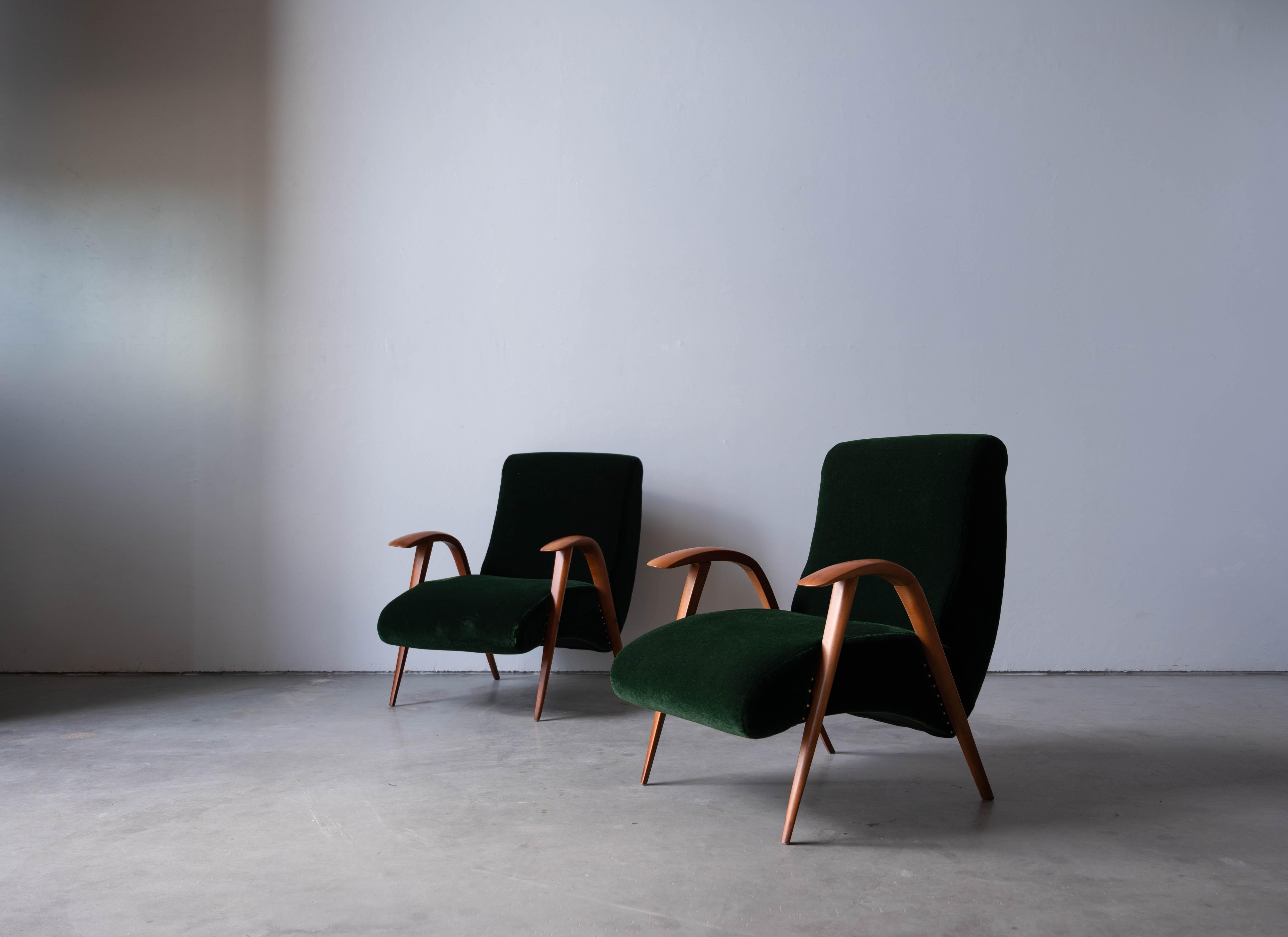 A pair of wood and green velvet lounge chair designed and produced in Italy, 1940s. 



