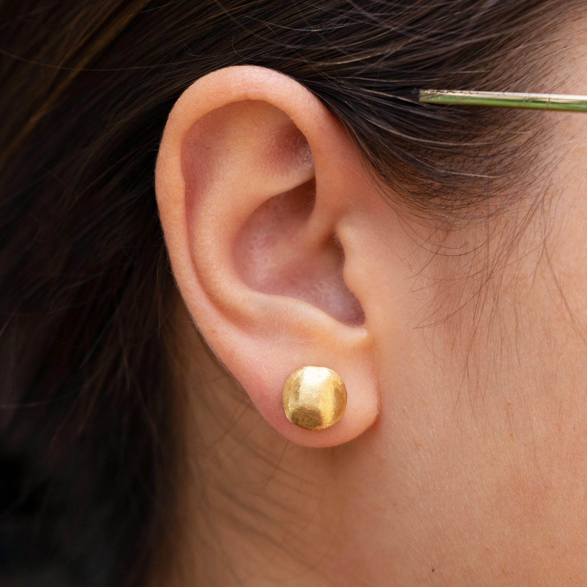 A sumptuous set of signed Marco Bicego earrings, from the Italian designer's Africa collection. A hand florentine finish, an ancient technique, is bespoke into the 18 karat yellow gold studs. An affordable luxury, these earrings will exemplify your