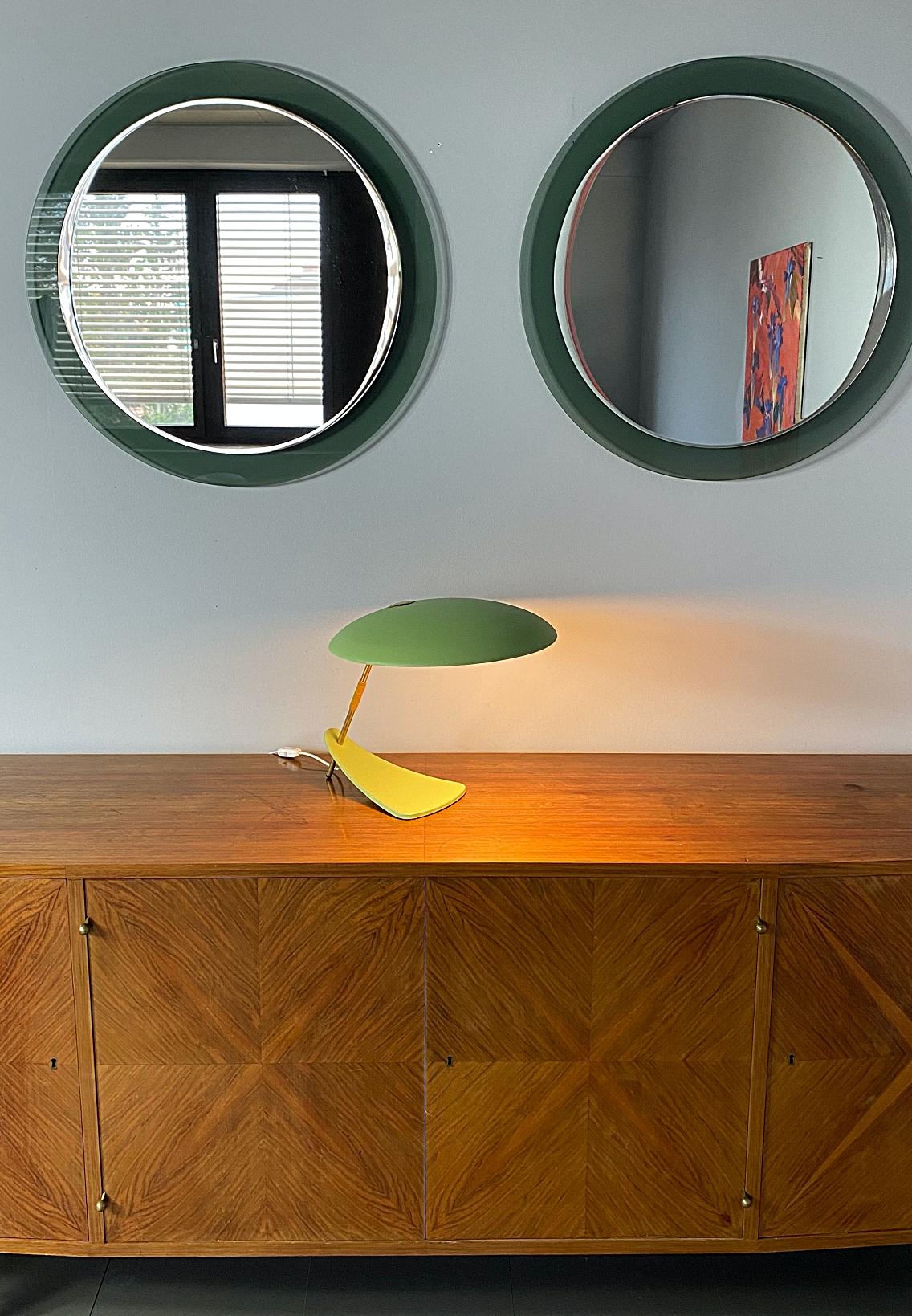 Iconic midcentury desk lamp in pistachio wrinkle paint with brass details. Minimalistic design from the 1950s, big round shade with cast iron beak-shaped base. The shade provides a smooth large-area light. Nice patina without bumps or dents. Newly