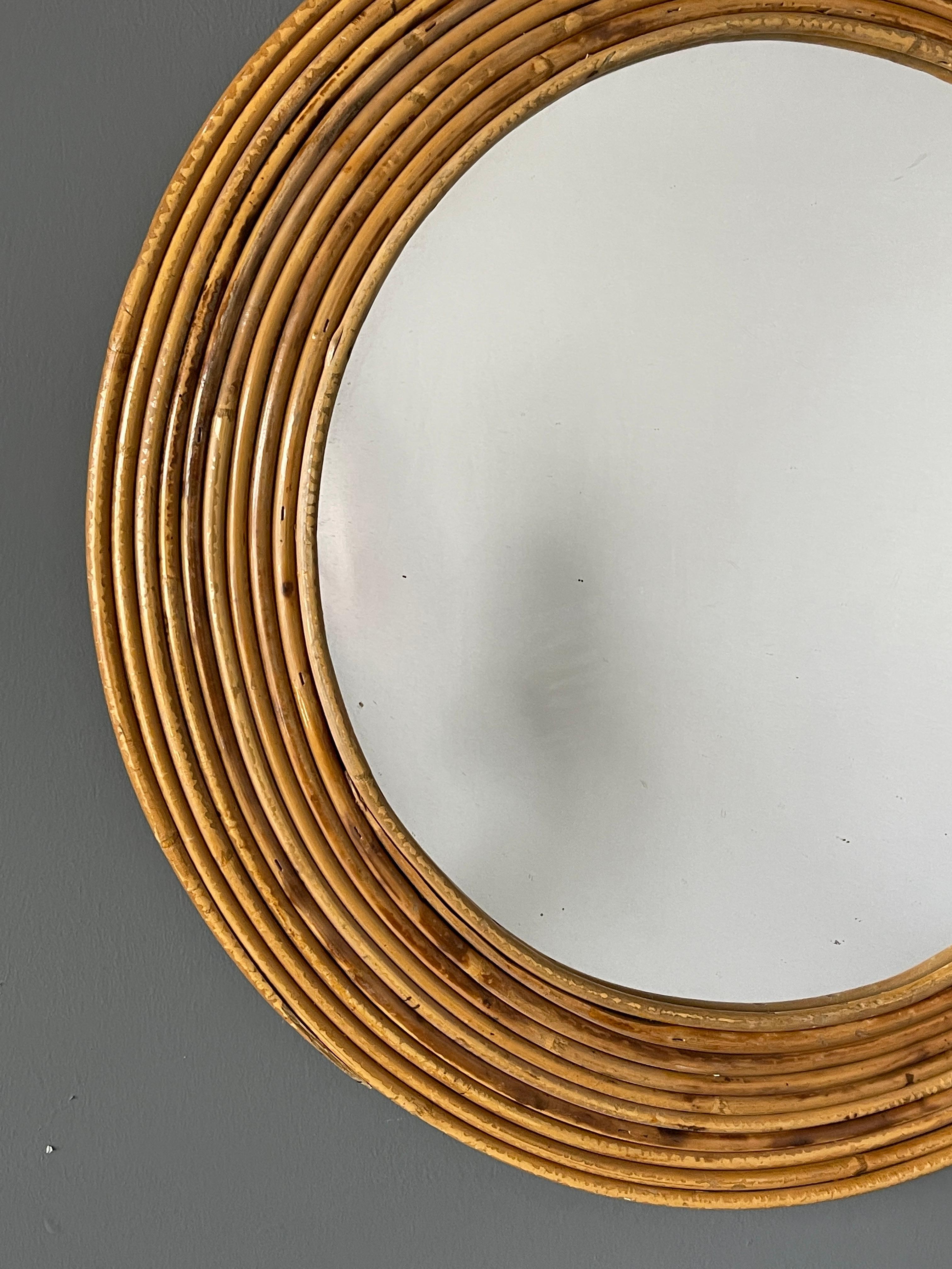 A wall mirror, produced in Italy, 1950s. Cut mirror glass is framed in bamboo and rattan

Other designers of the period include Gio Ponti, Fontana Arte, Max Ingrand, Franco Albini, and Josef Frank.