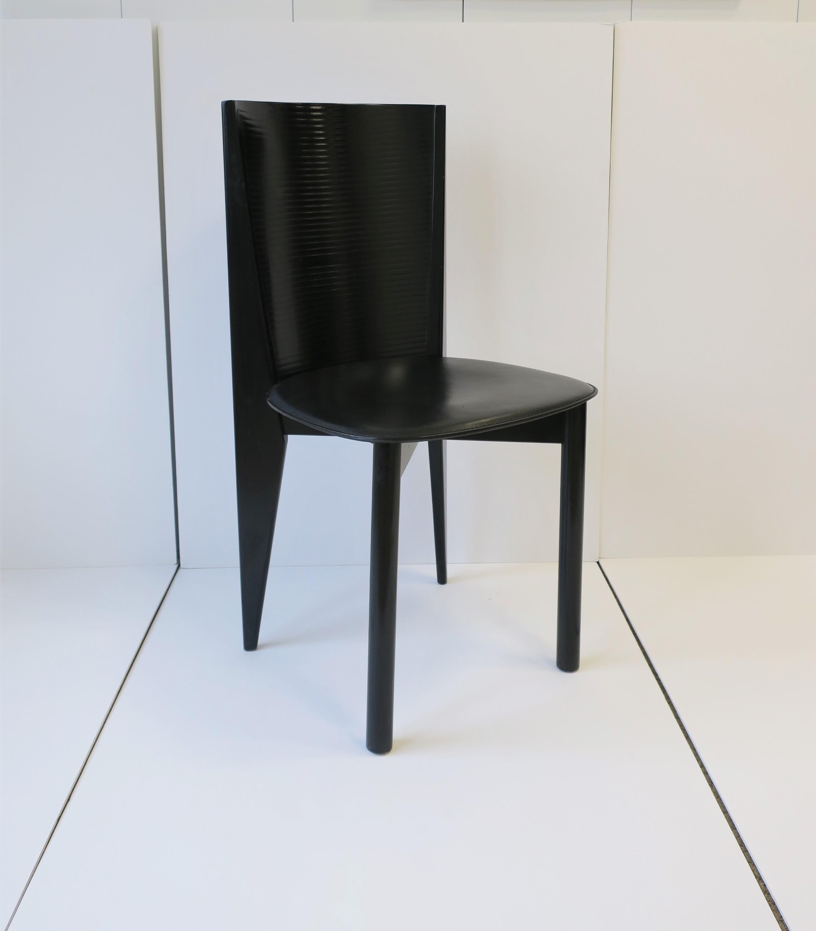 A very beautiful and chic Italian modern style or Postmodern period black lacquer wood and leather side or desk chair(s), circa late 20th century, late-1970s-1980s, Italy. Beautiful detailing in chair legs and back. With maker's mark on bottom: