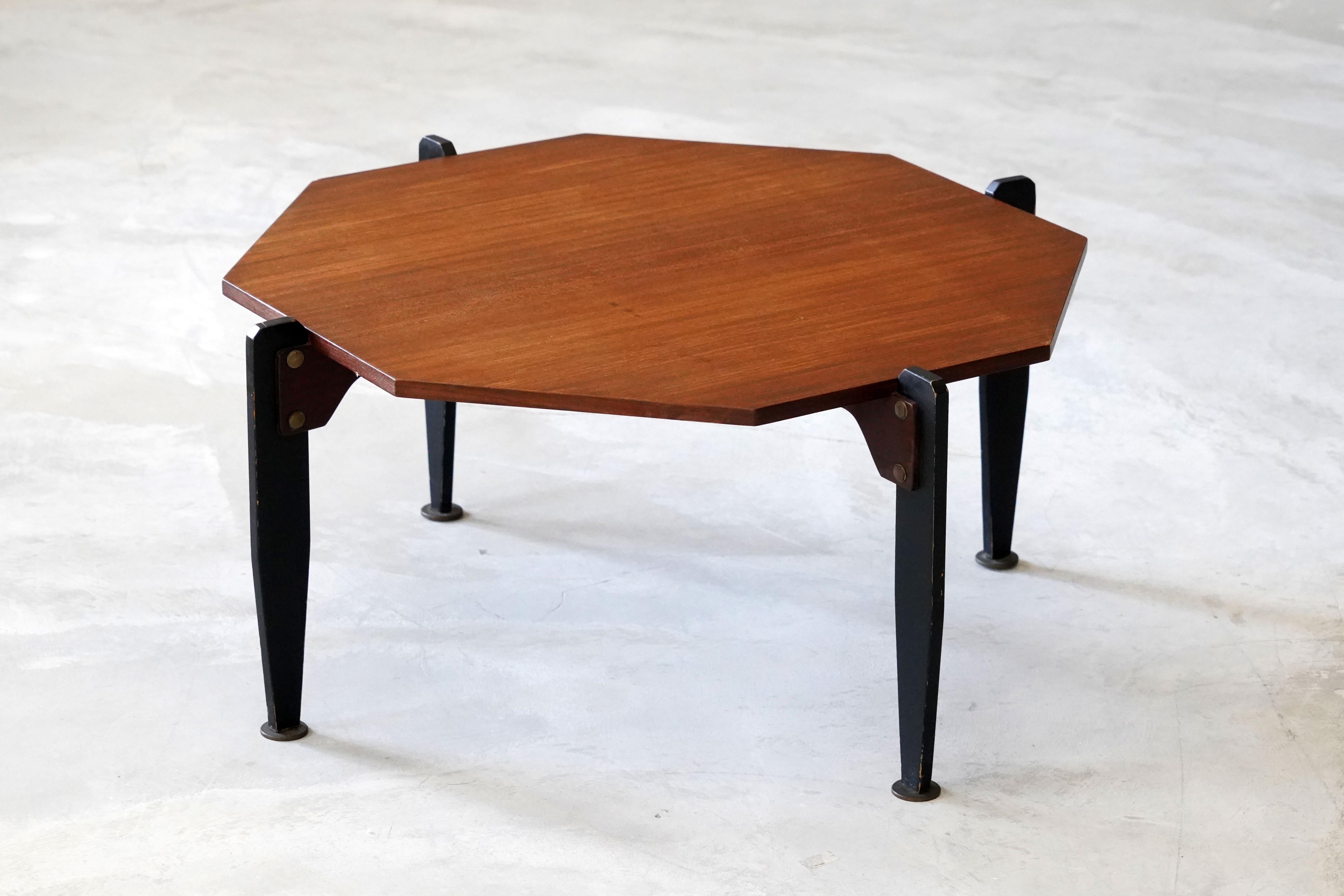 A modernist coffee table / cocktail table. Designed and produced in Italy, 1950s. Executed in stained metal and teak. A light table that can also be utilized as an occasional or end table.

Other designers of the period include Gio Ponti, Ico