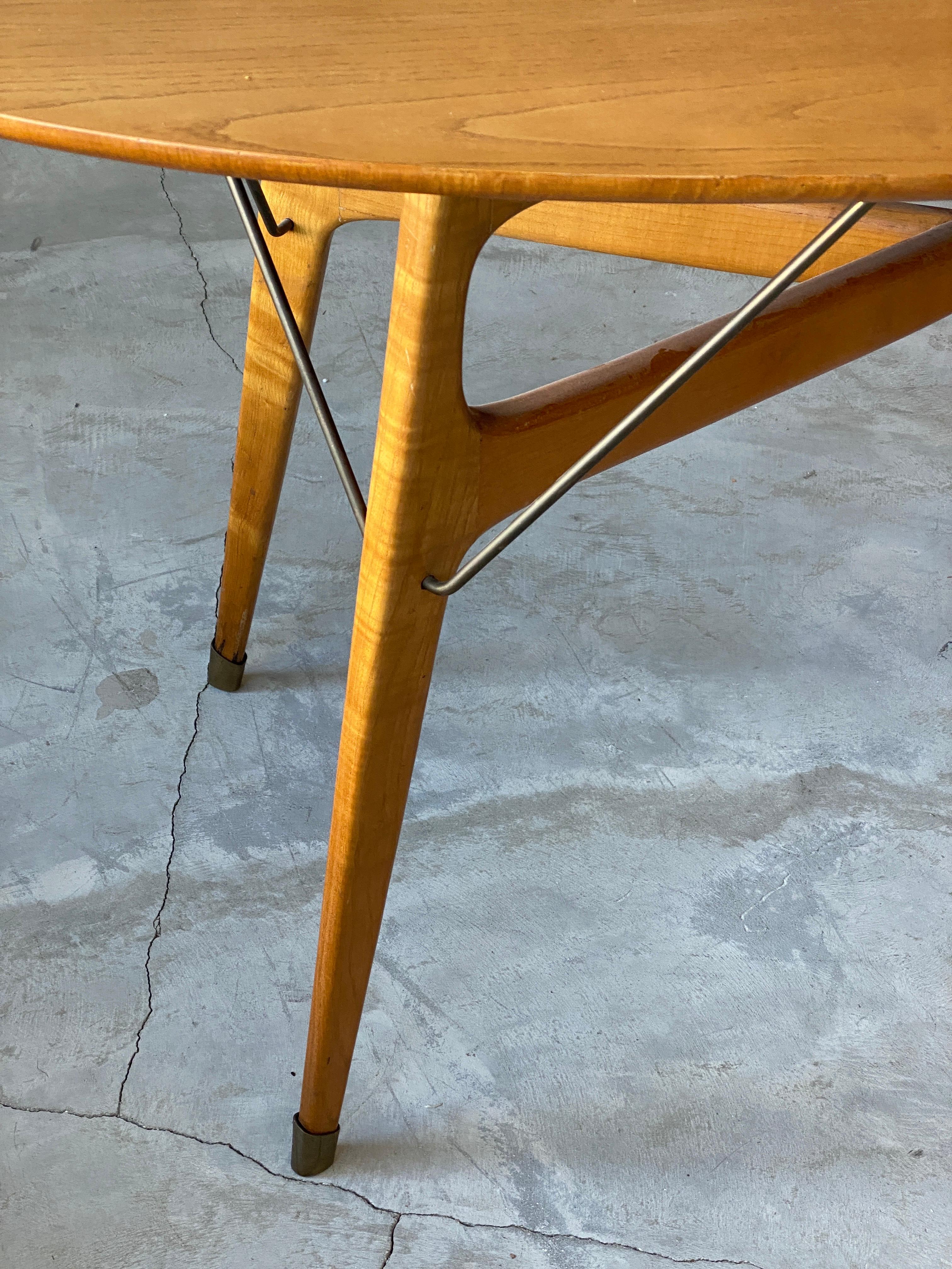 A small dinette / dining table. Finely sculpted solid beach reinforced with brass details. 

Other designers of the period include Gio Ponti, Franco Albini, Paolo Buffa, Ico Parisi, and Carlo Mollino.