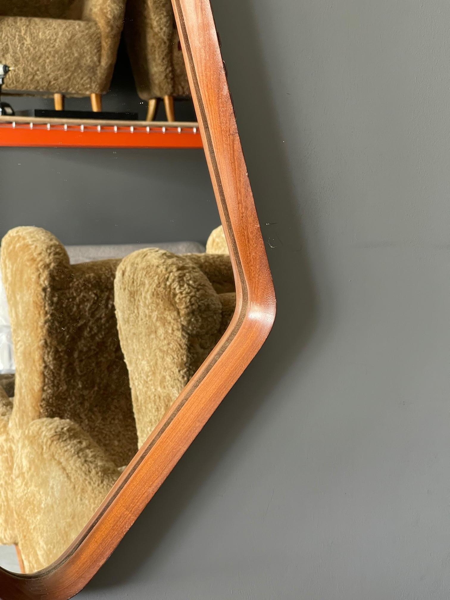 A wall mirror, produced in Italy, 1950s. Cut mirror glass is framed in finely carved walnut frame.

Other designers of the period include Gio Ponti, Fontana Arte, Paolo Buffa, Franco Albini, and Jean Royere.