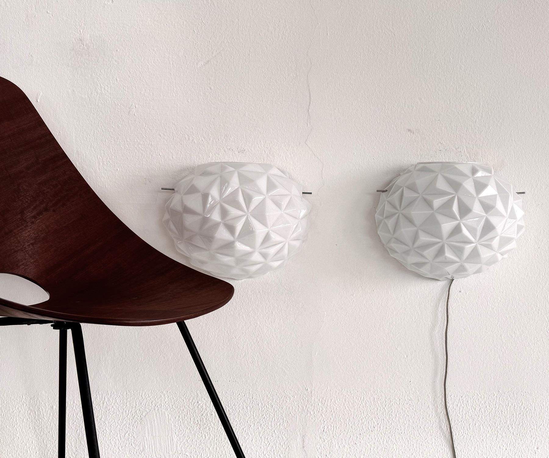 Italian Large Designer Murano Glass Wall Sconces in Modern Geometric Shape, 1990

Beautiful pair of shiny white, large wall sconces made of Murano glass in very modern geometric shape.
Gorgeous to look at when not illuminated, but when illuminated
