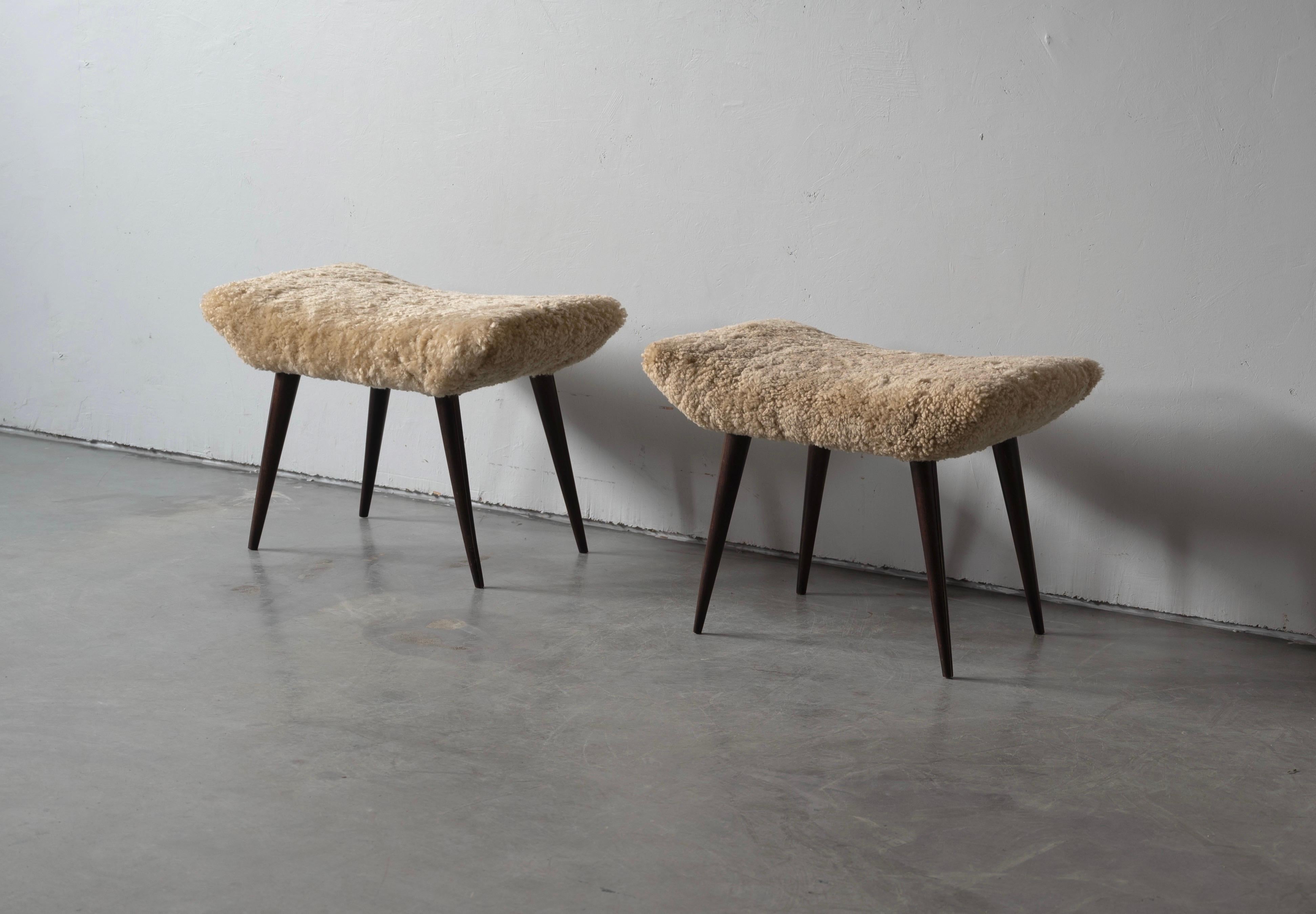 A pair of organic stools in stained walnut, overstuffed seat reupholstered in brand new sheepskin upholstery. Produced in Italy, 1940s-1950s.

Other designers of the period include Finn Juhl, Hans Wegner, Isamu Noguchi, Charlotte Perriand.