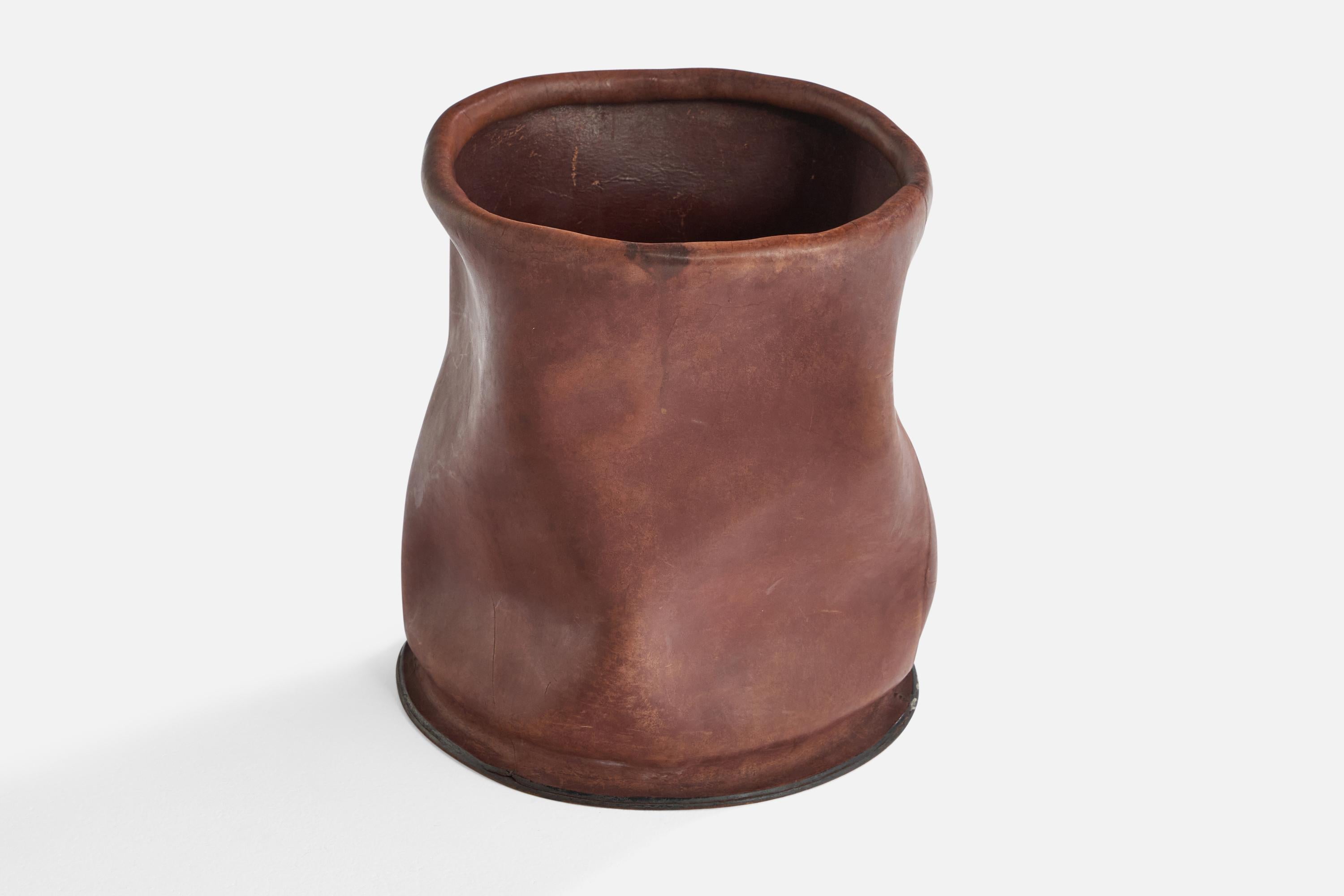 A wet-moulded leather umbrella stand designed and produced in Bologna, Italy, c. 1970s.