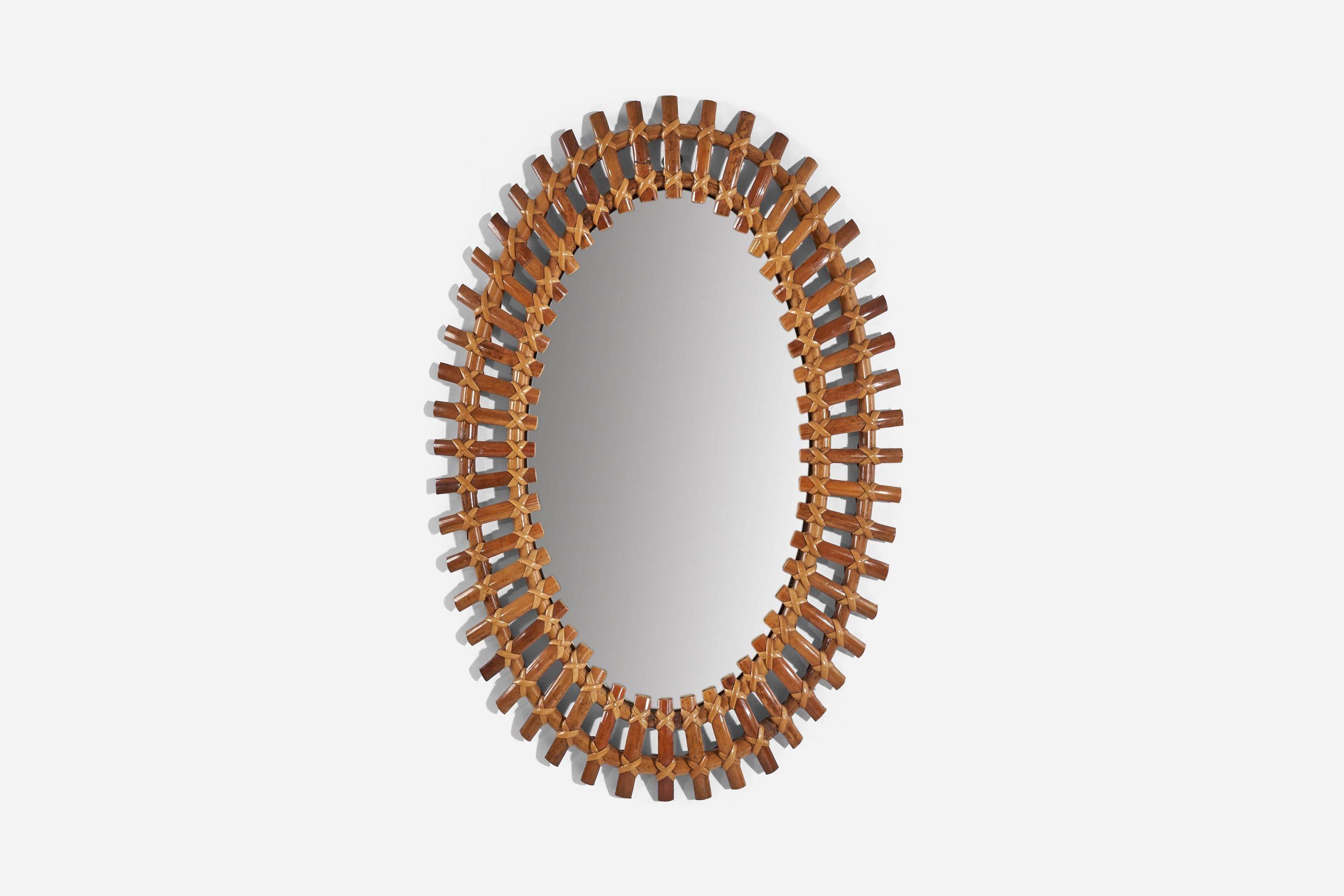 An oval, rattan wall mirror designed and produced by an Italian designer, Italy, 1950s-1960s.
 