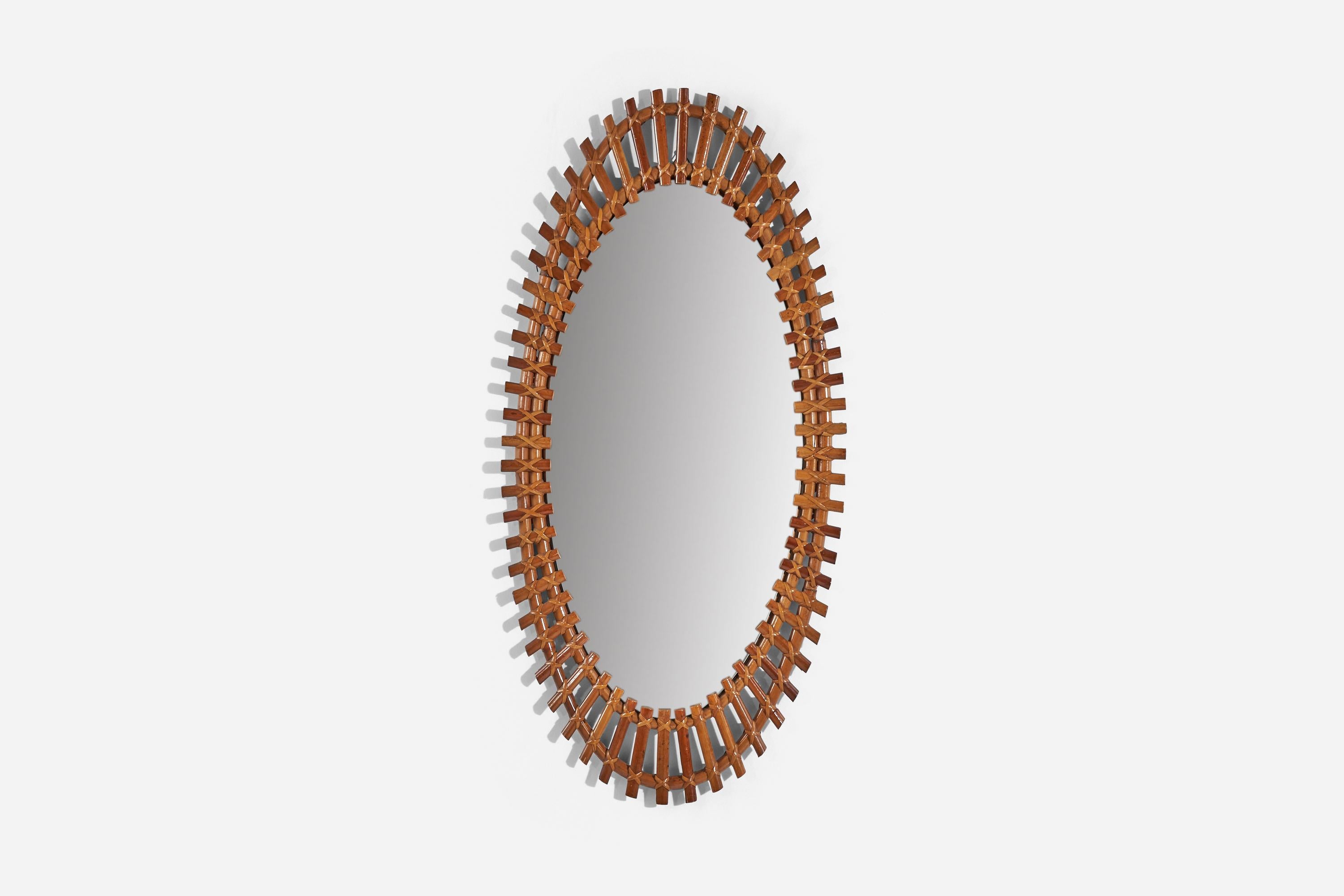 An oval, rattan and bamboo wall mirror designed and produced by an Italian designer, Italy, 1950s-1960s.
 