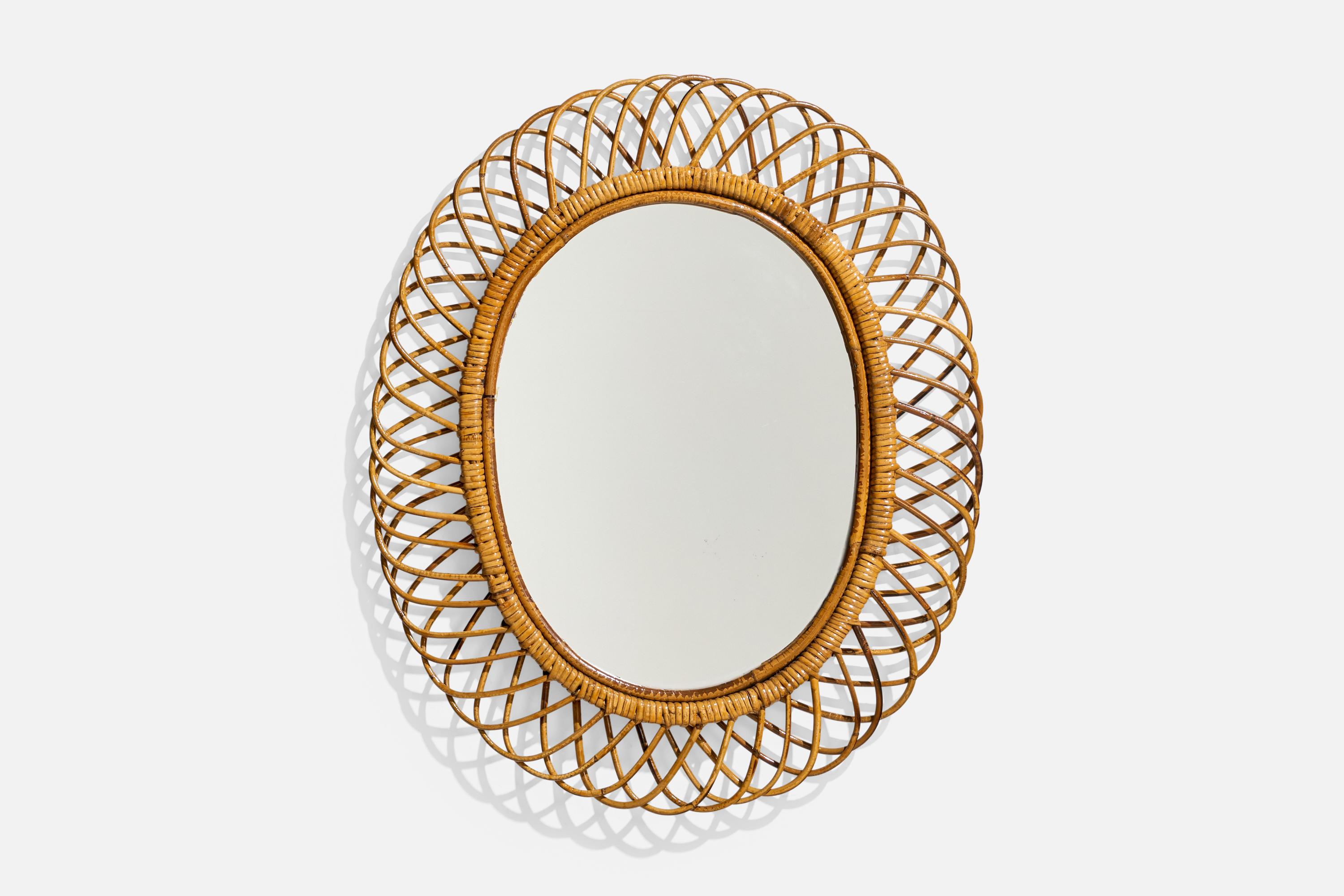 An oval, rattan wall mirror designed and produced by an Italian designer, Italy, 1950s-1960s.
 