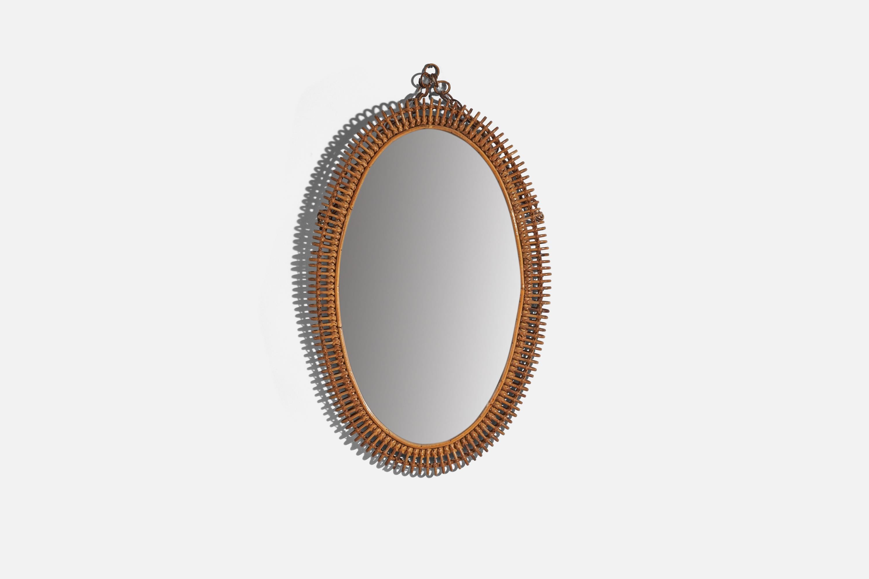 An oval, rattan wall mirror designed and produced by an Italian designer, Italy, 1950s-1960s.
 