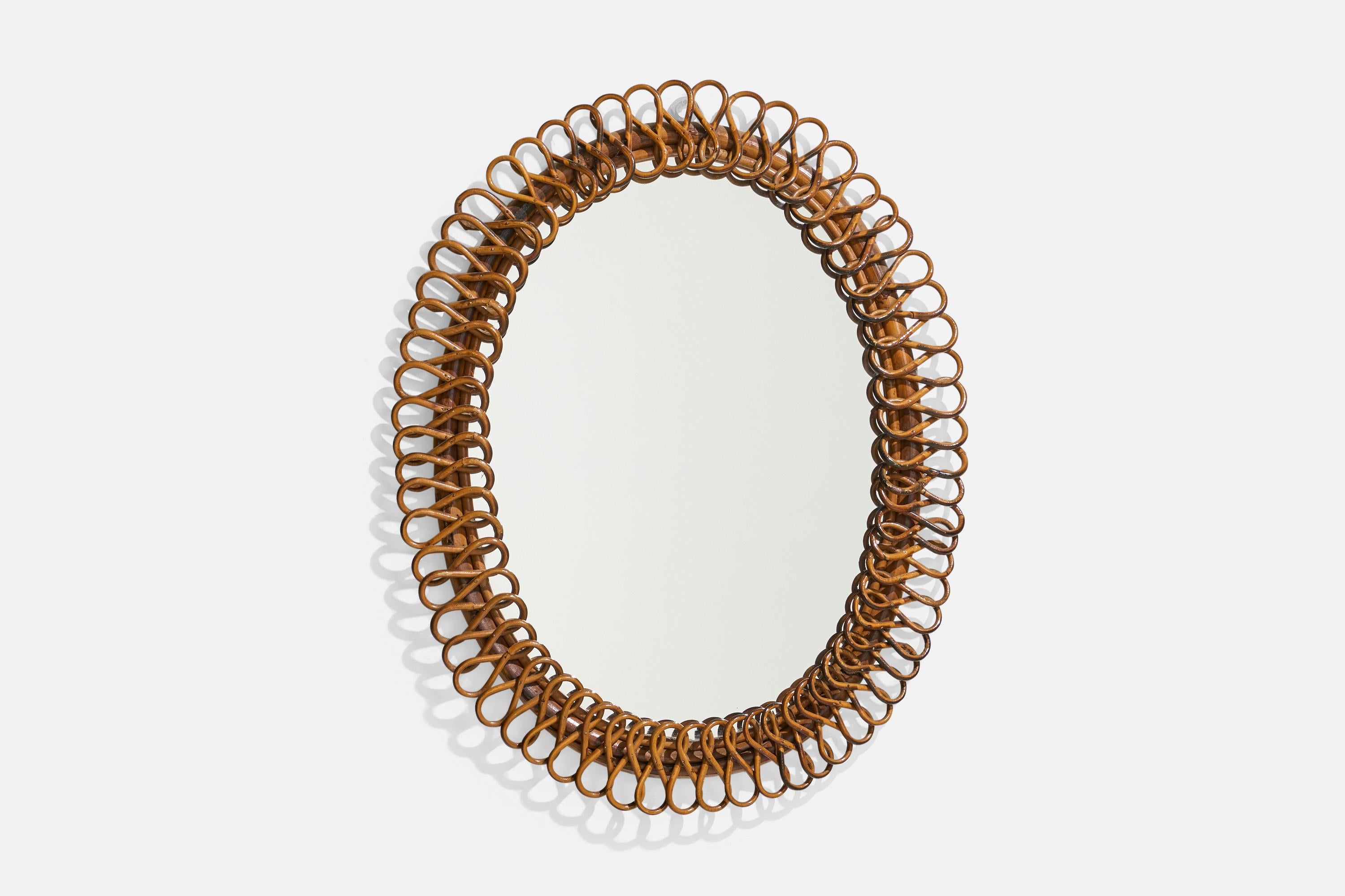 An oval, rattan wall mirror designed and produced by an Italian designer, Italy, 1950s-1960s.
 