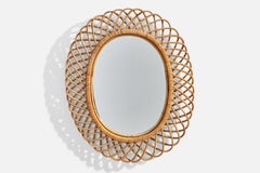 Italienischer italienischer Designer, ovaler Wandspiegel, Rattan, Spiegelglas, Italien, ca. 1950er Jahre