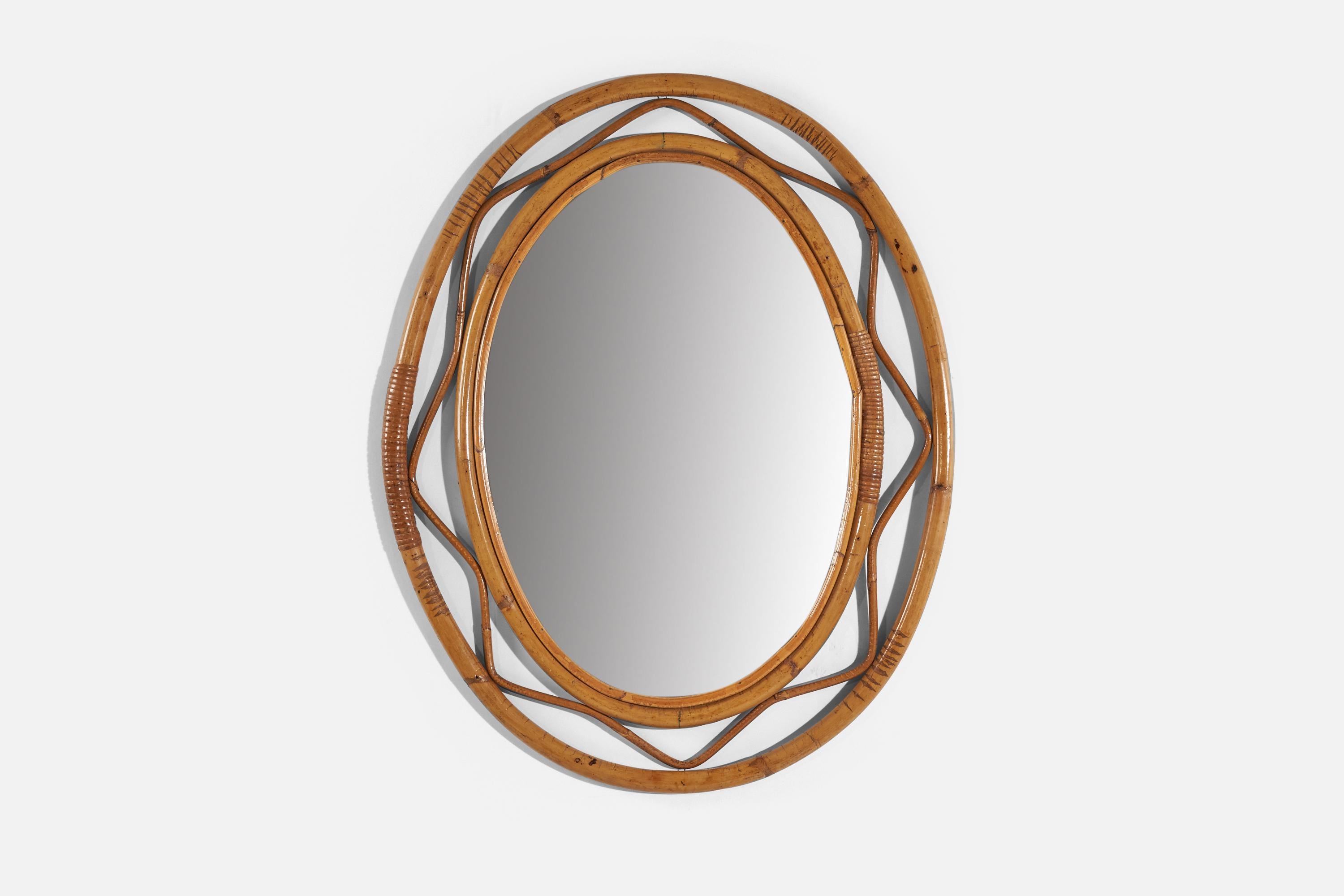 An oval, rattan wall mirror designed and produced by an Italian designer, Italy, 1950s-1960s.
    