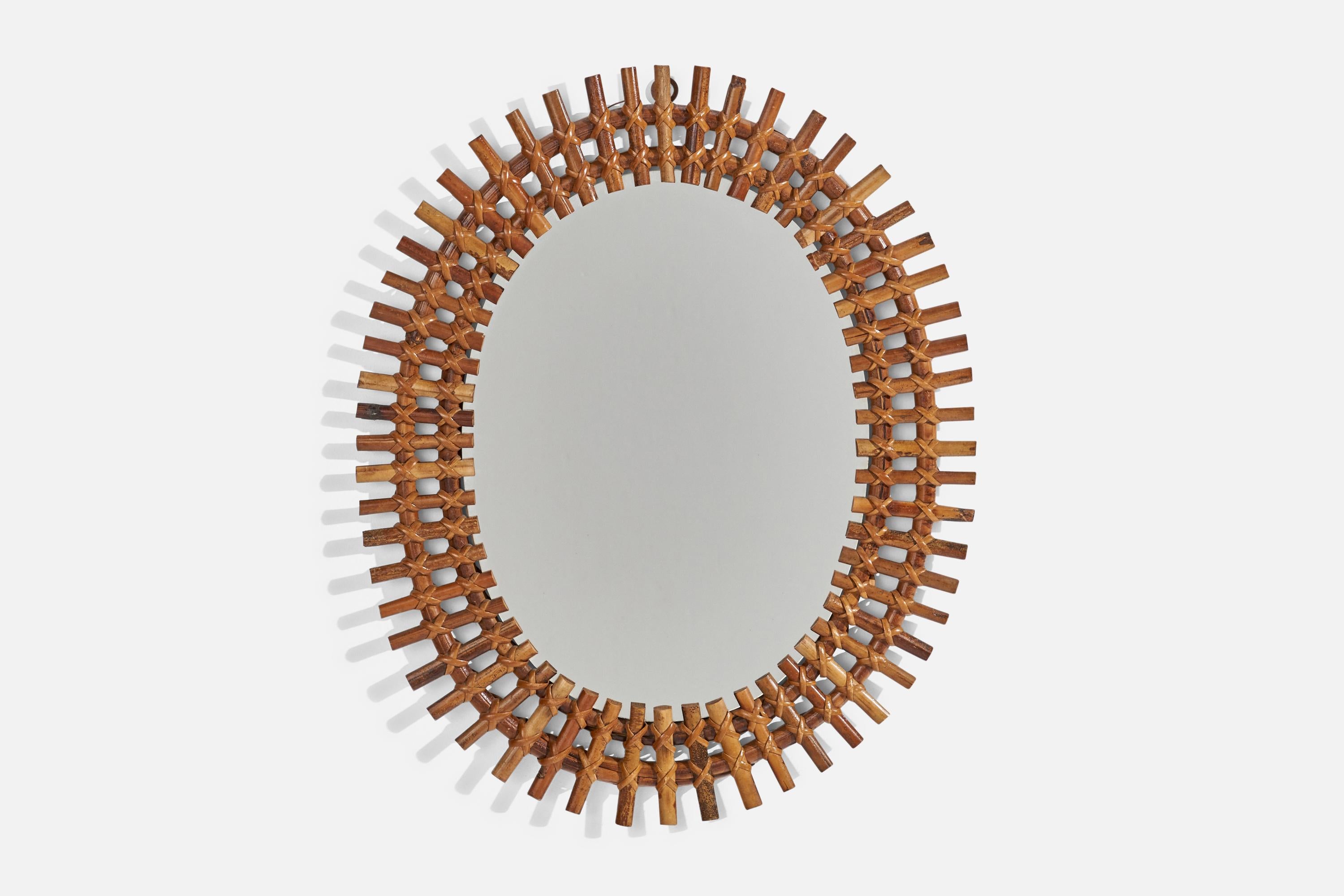 An oval, rattan wall mirror designed and produced by an Italian designer, Italy, 1950s-1960s.
 