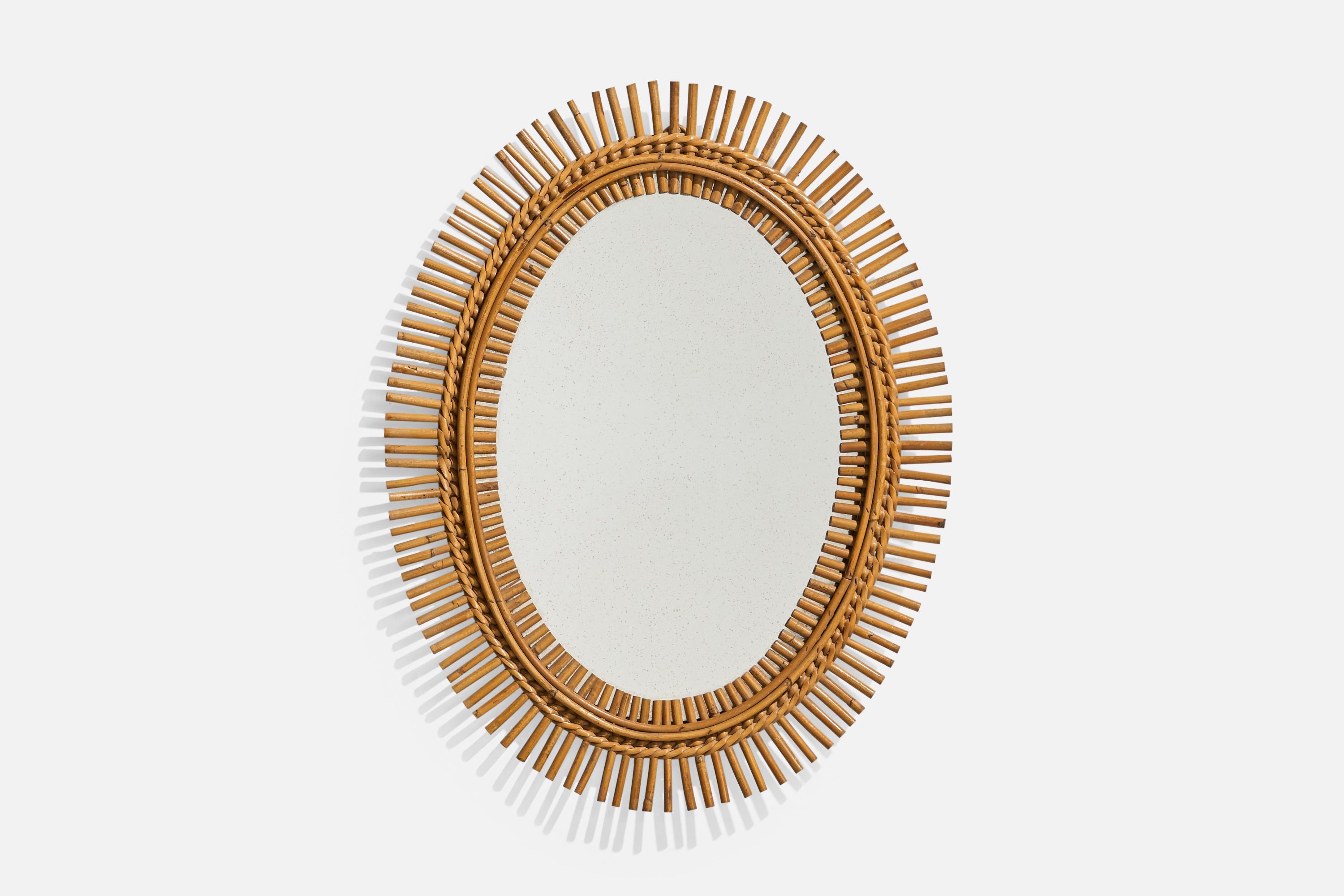 An oval, rattan wall mirror designed and produced by an Italian designer, Italy, 1950s-1960s.
 