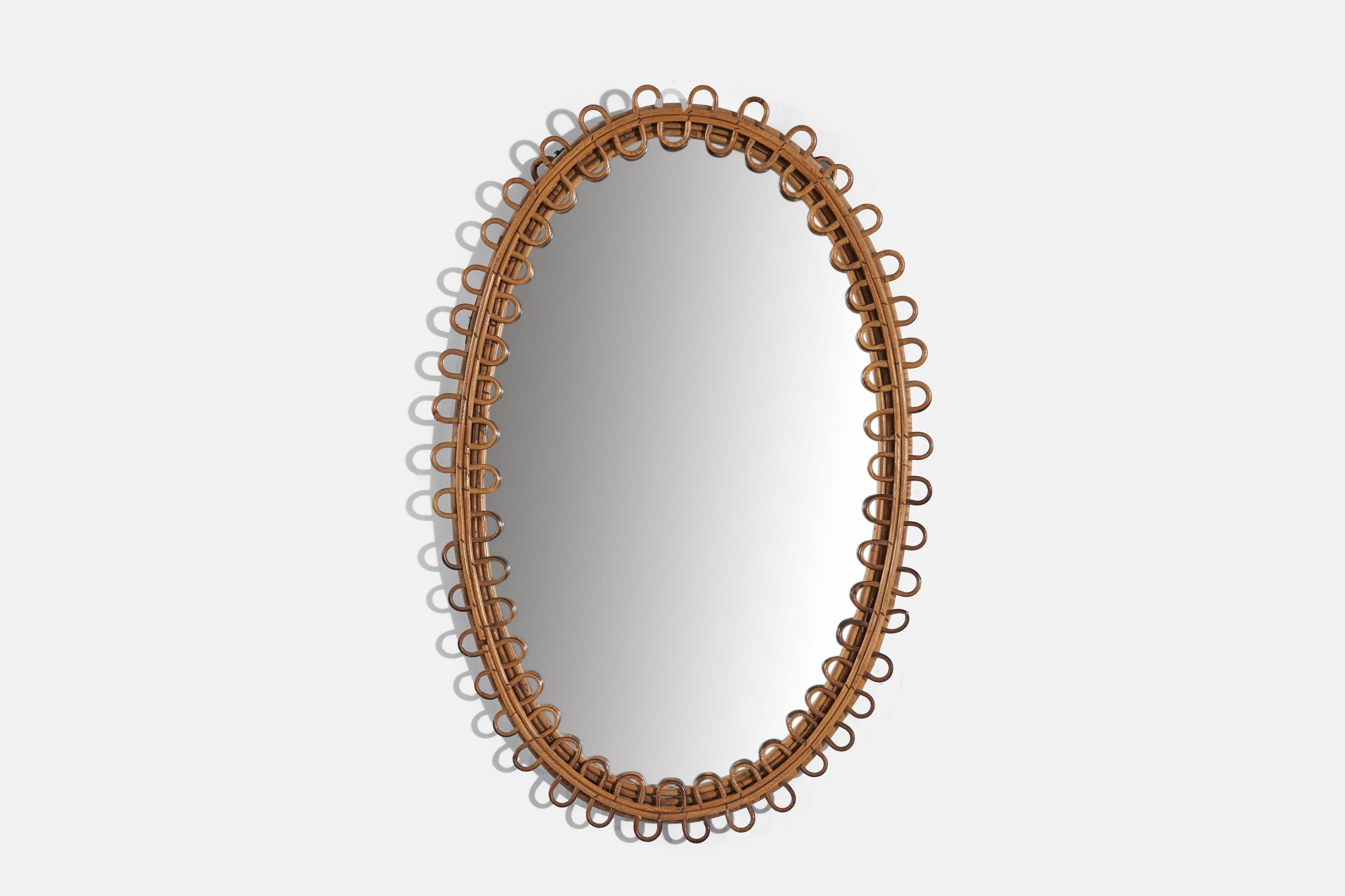 An oval rattan wall mirror designed and produced by an Italian designer, Italy, 1950s-1960s.
  