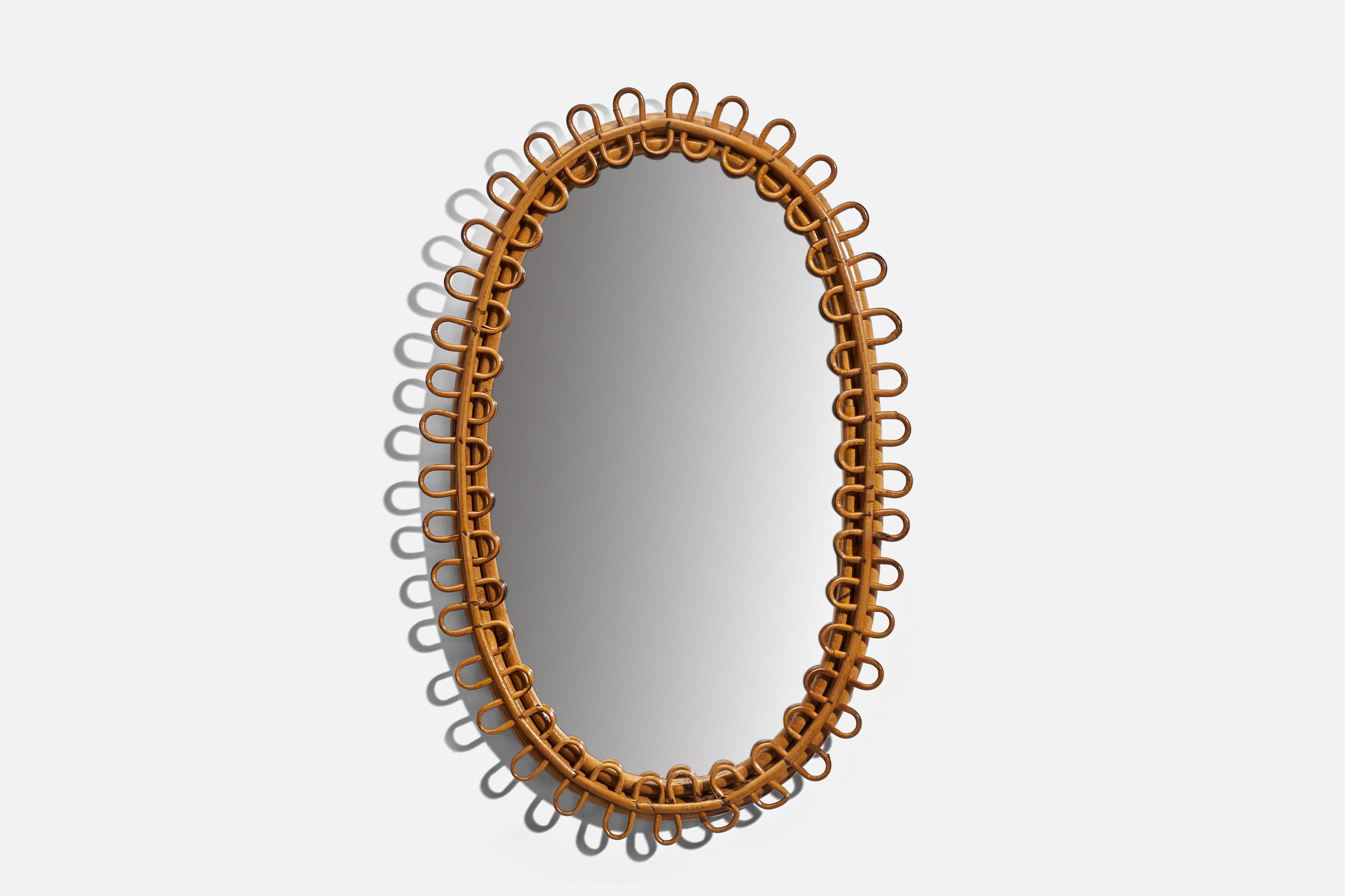 An oval, rattan wall mirror designed and produced by an Italian designer, Italy, 1950s-1960s.
  