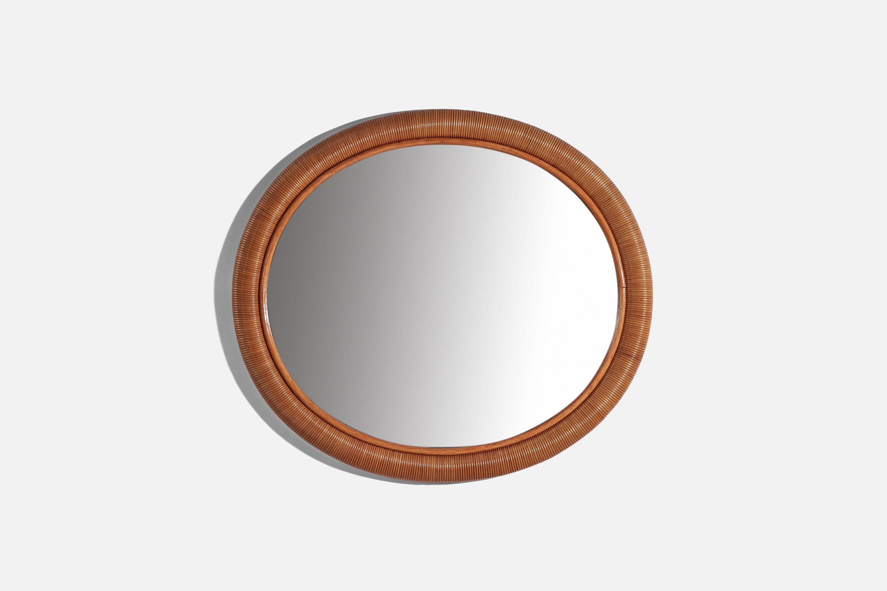 An oval, rattan wall mirror designed and produced by an Italian designer, Italy, 1950s-1960s.
  