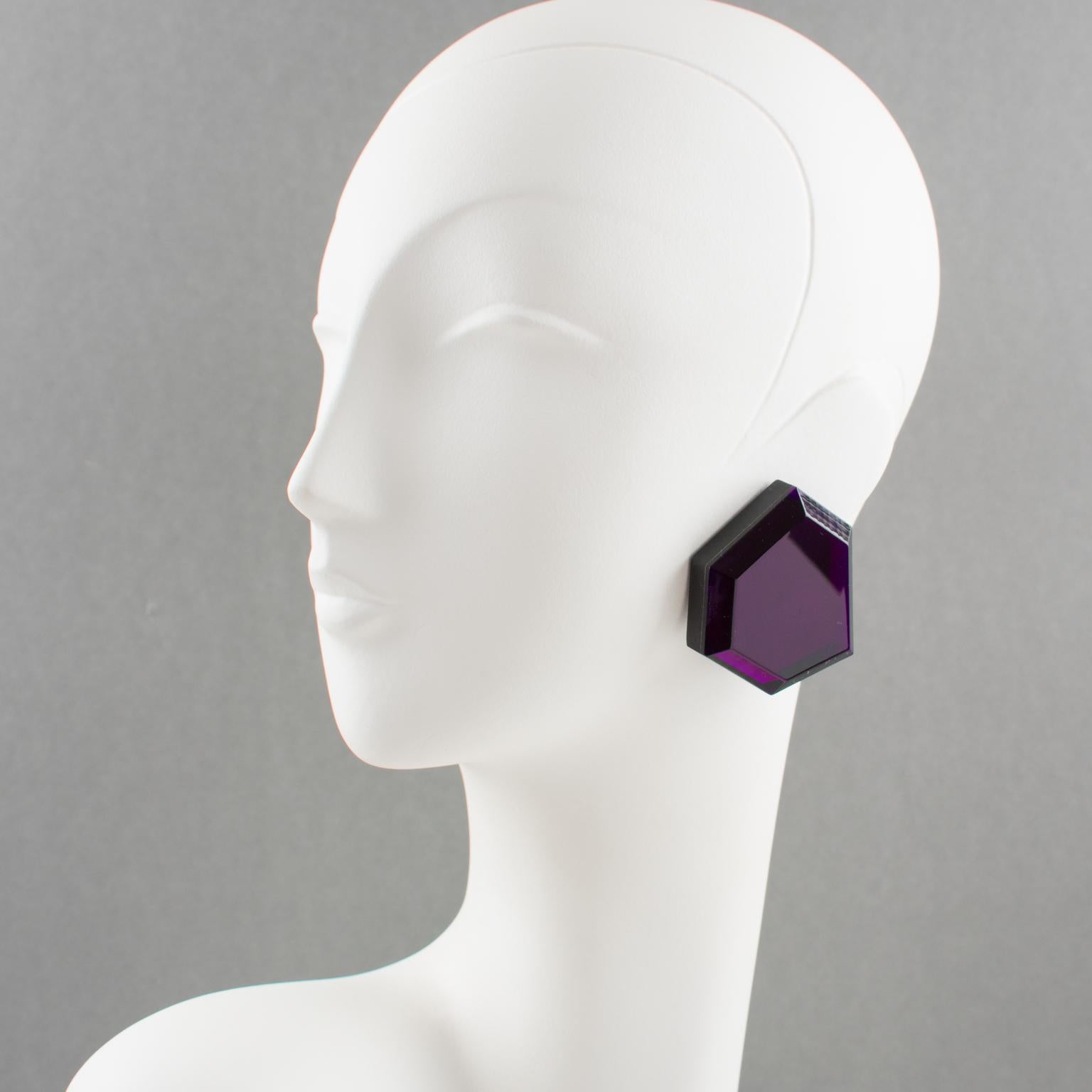 Beautiful oversized Lucite clip-on earrings from artisan designer studio. Huge flat geometric shape with intense purple color (fuchsia overtone color when placed in strong light) and large beveling. 
No visible maker's mark.
Measurements: 2.07 in.