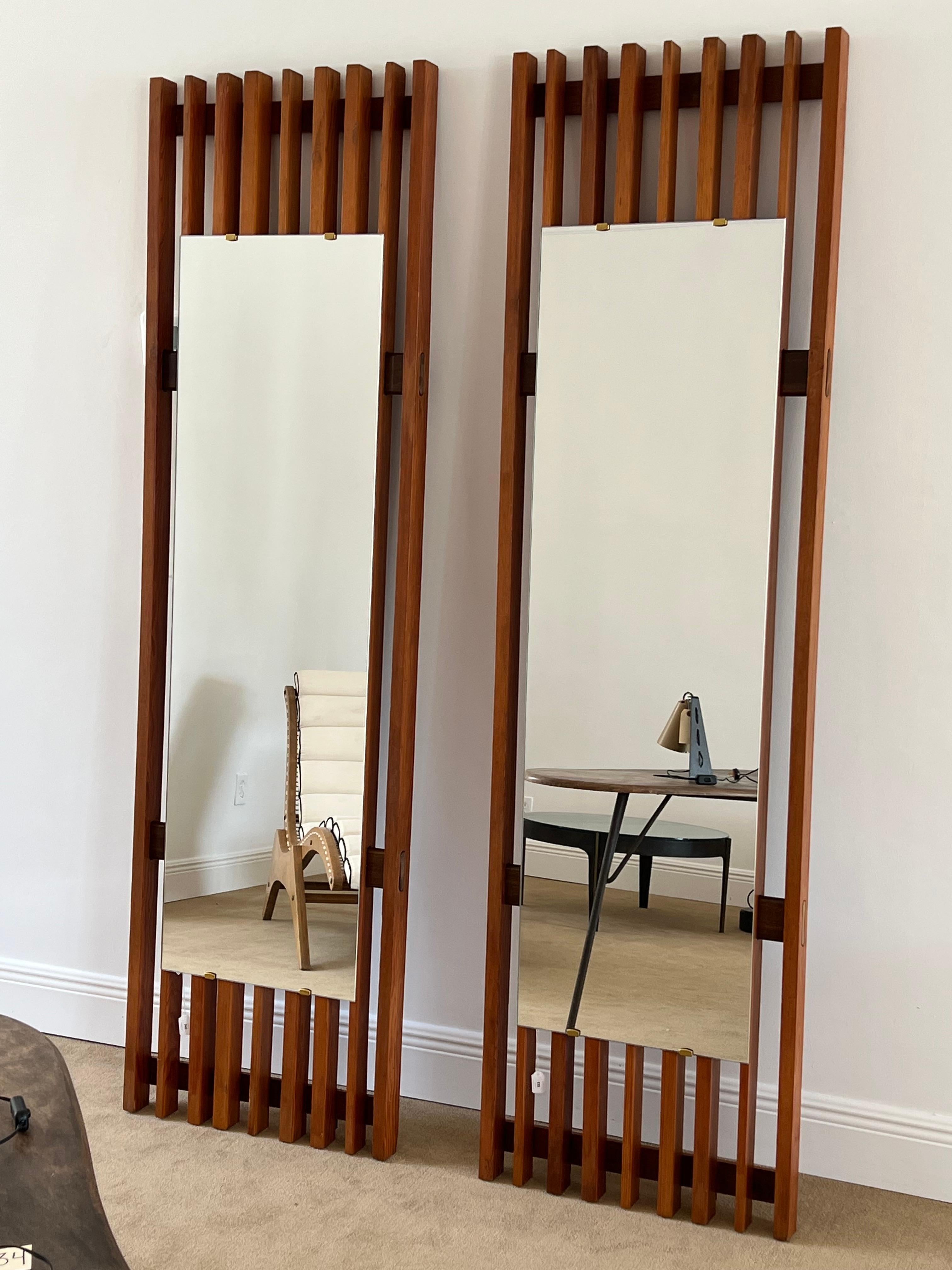 A pair of large pine and brass wall mirrors designed and produced in Italy, c. 1960s.
  