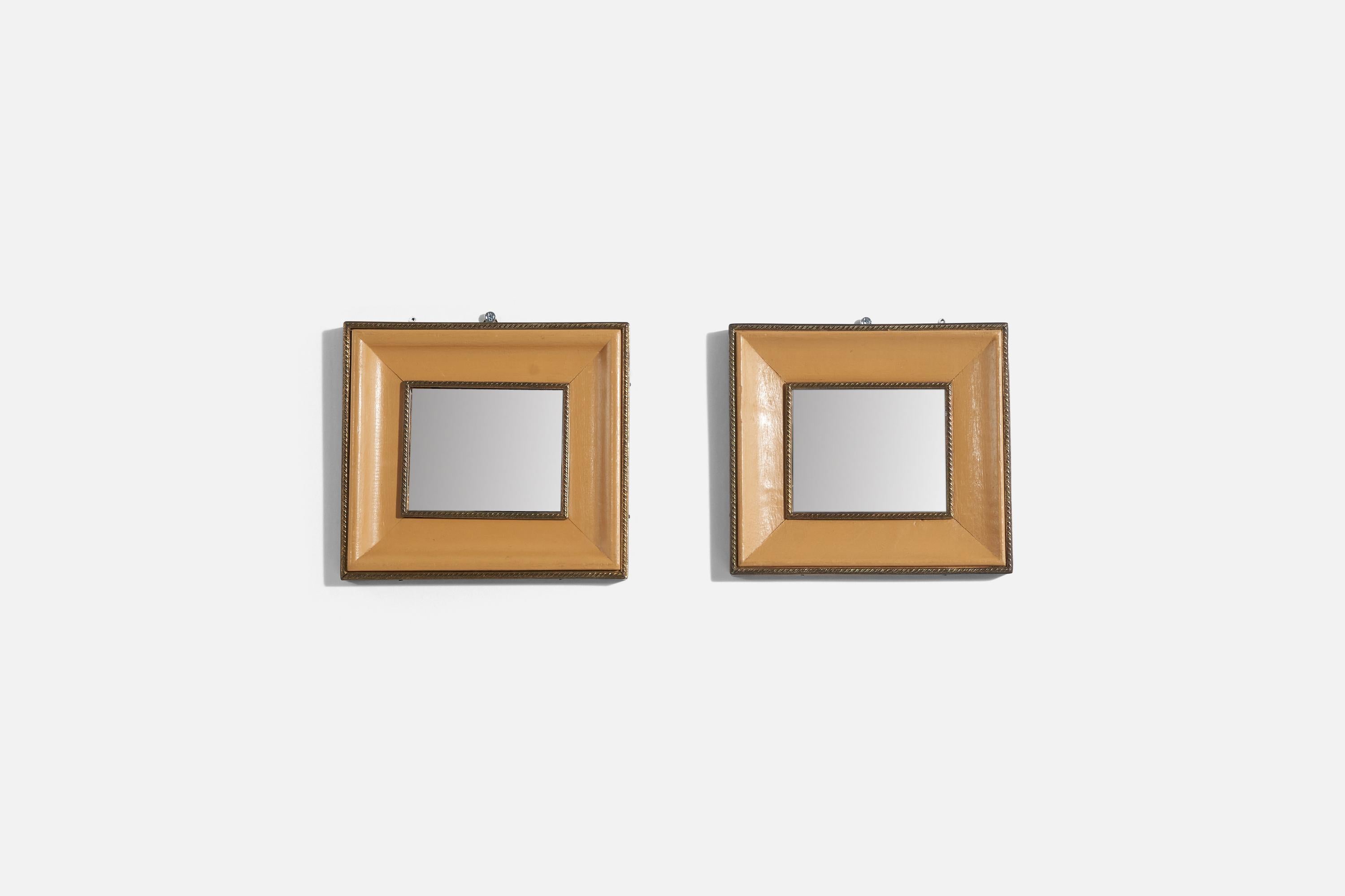 A pair of brass and leather wall mirrors produced in Italy, 1940s.
 
