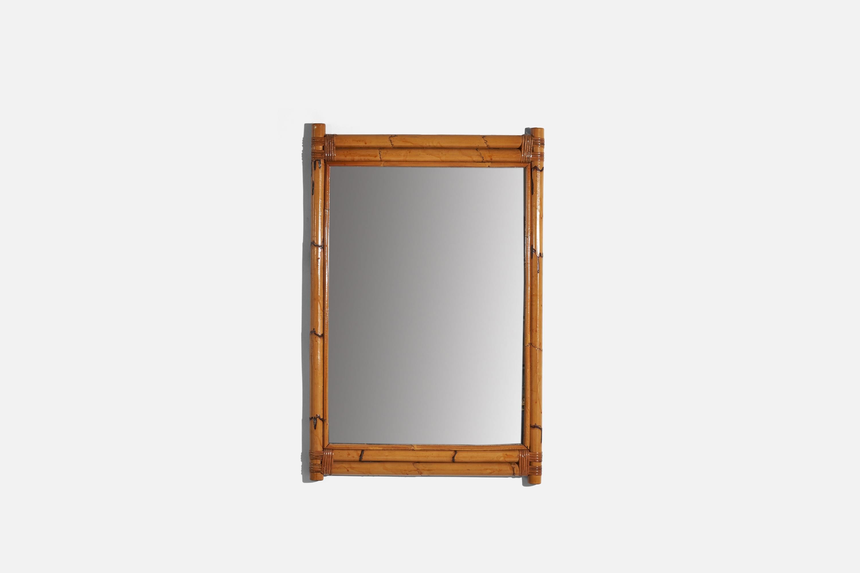 A bamboo and rattan wall mirror designed and produced in Italy, c. 1950s.