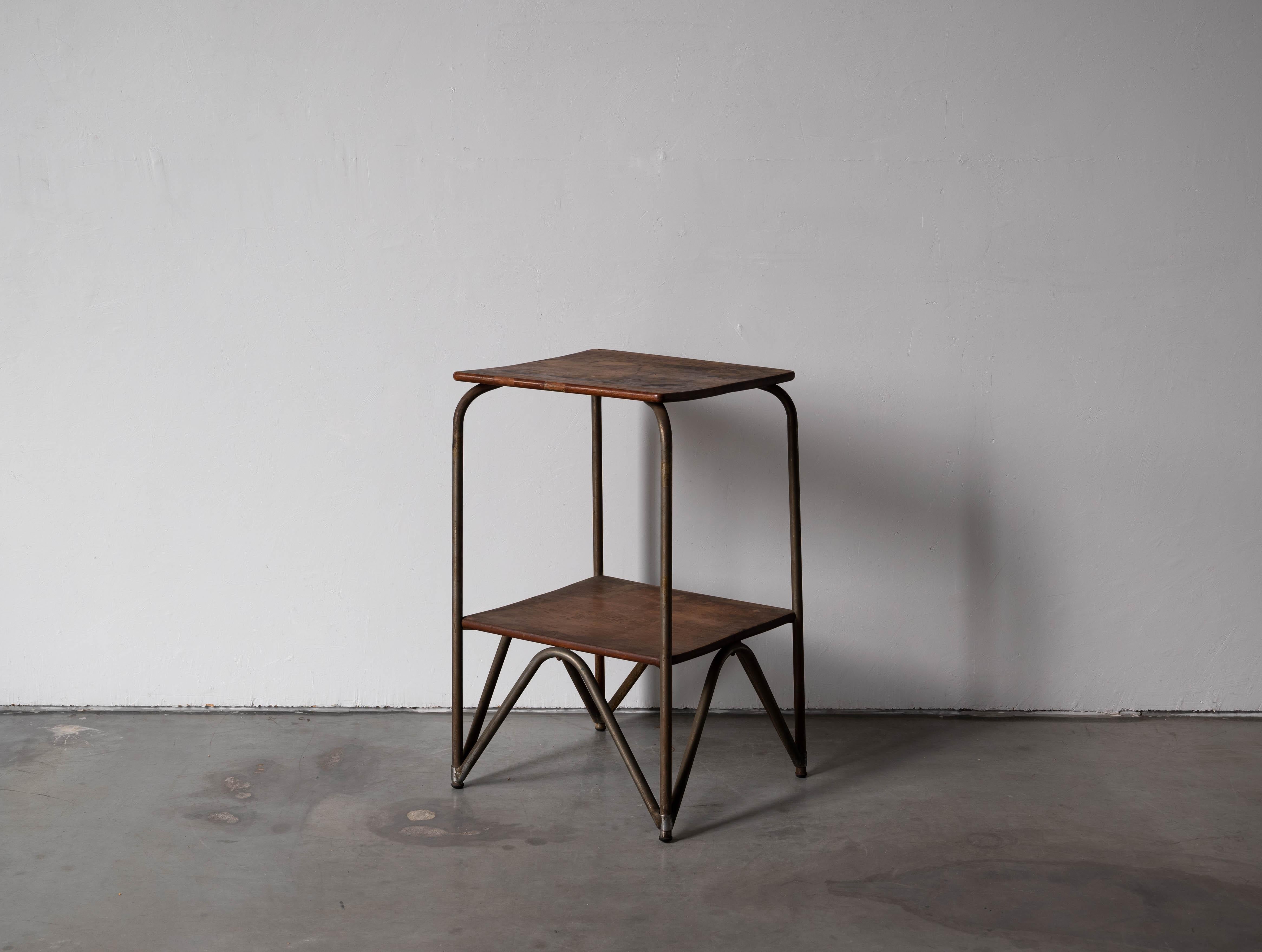 A walnut and iron side table / or end table produced in Italy, 1930s.

