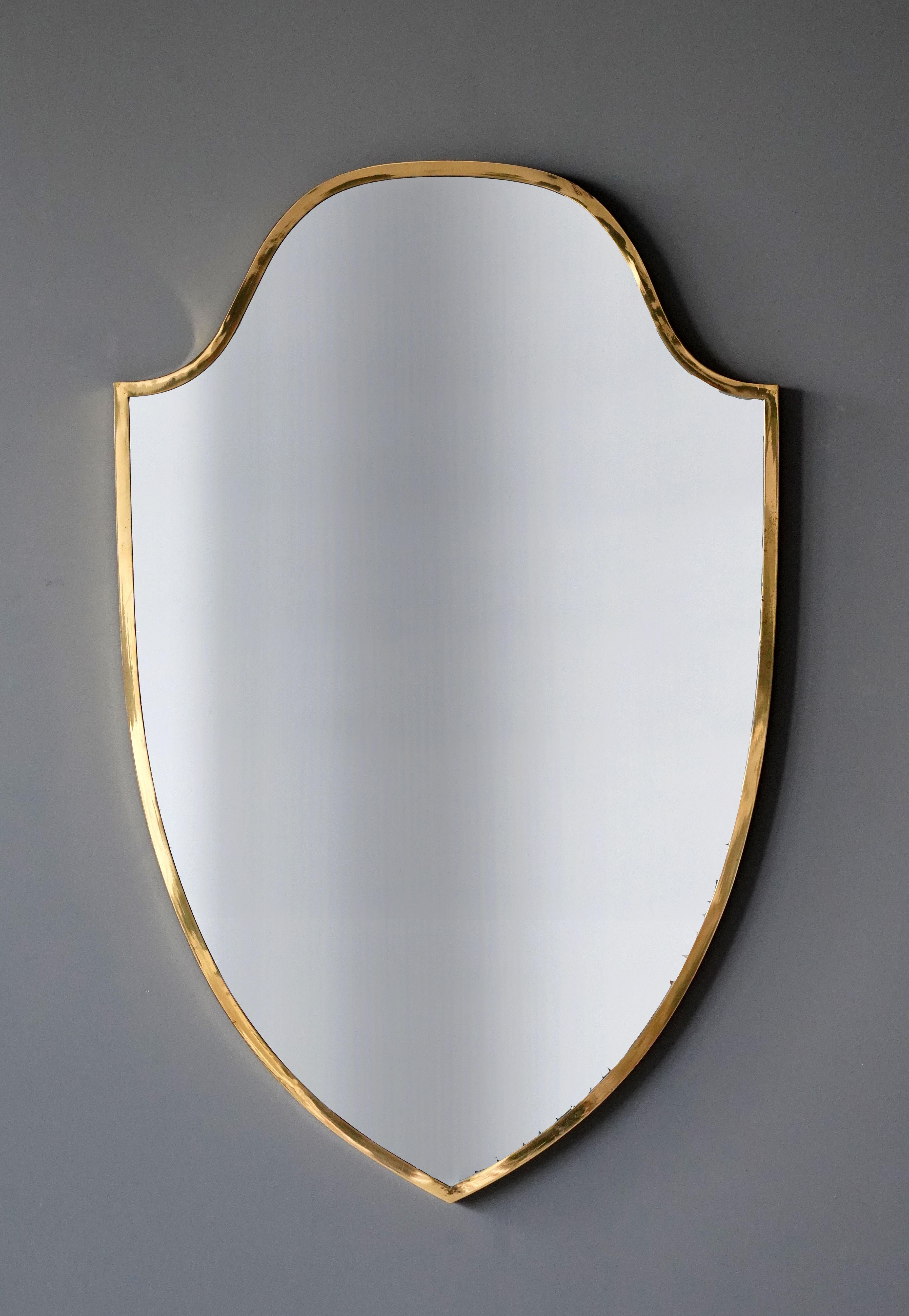 A wall mirror, produced in Italy, 1960s. Cut mirror glass is framed in brass frame.

Other designers of the period include Gio Ponti, Fontana Arte, Paolo Buffa, Franco Albini, and Jean Royere.