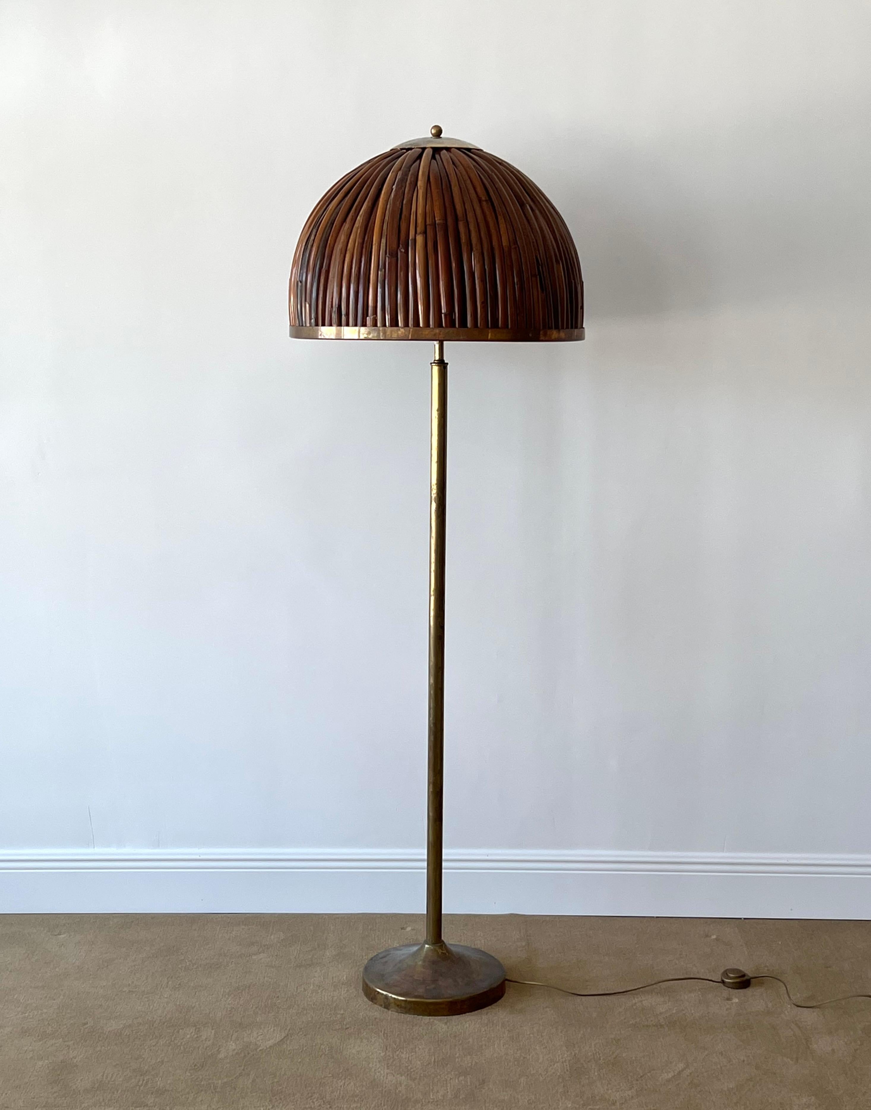 A sizeable brass and rattan floor lamp designed and produced in Italy, c. 1960s.

 