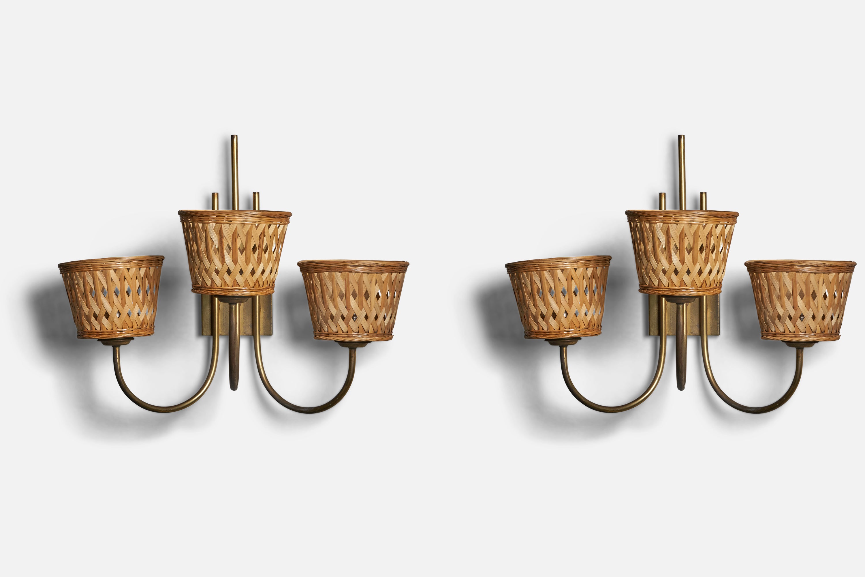 A pair of sizeable three armed brass and rattan wall lights, designed and produced in Italy, 1940s.

Overall Dimensions (inches): 19