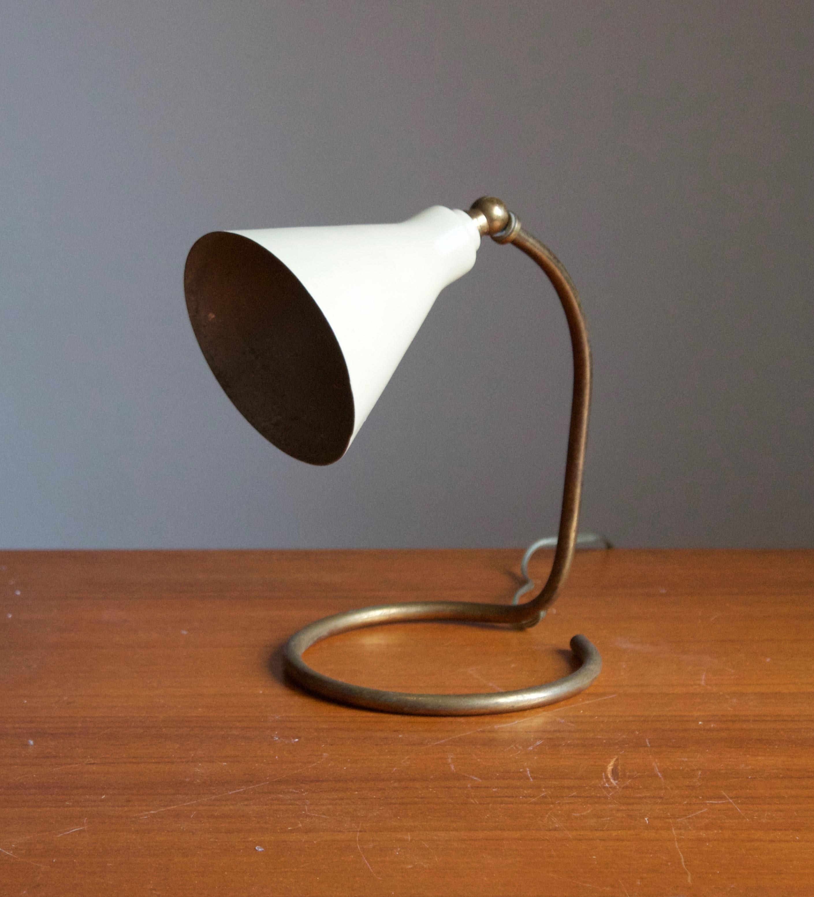 A small table lamp / desk light. Designed by an unknown Italian designer. Produced in Italy, 1950s. Features a sculpted brass base, white lacquered metal screen. 

Other Italian lighting designers of the period include Angelo Lelii, Max Ingrand,