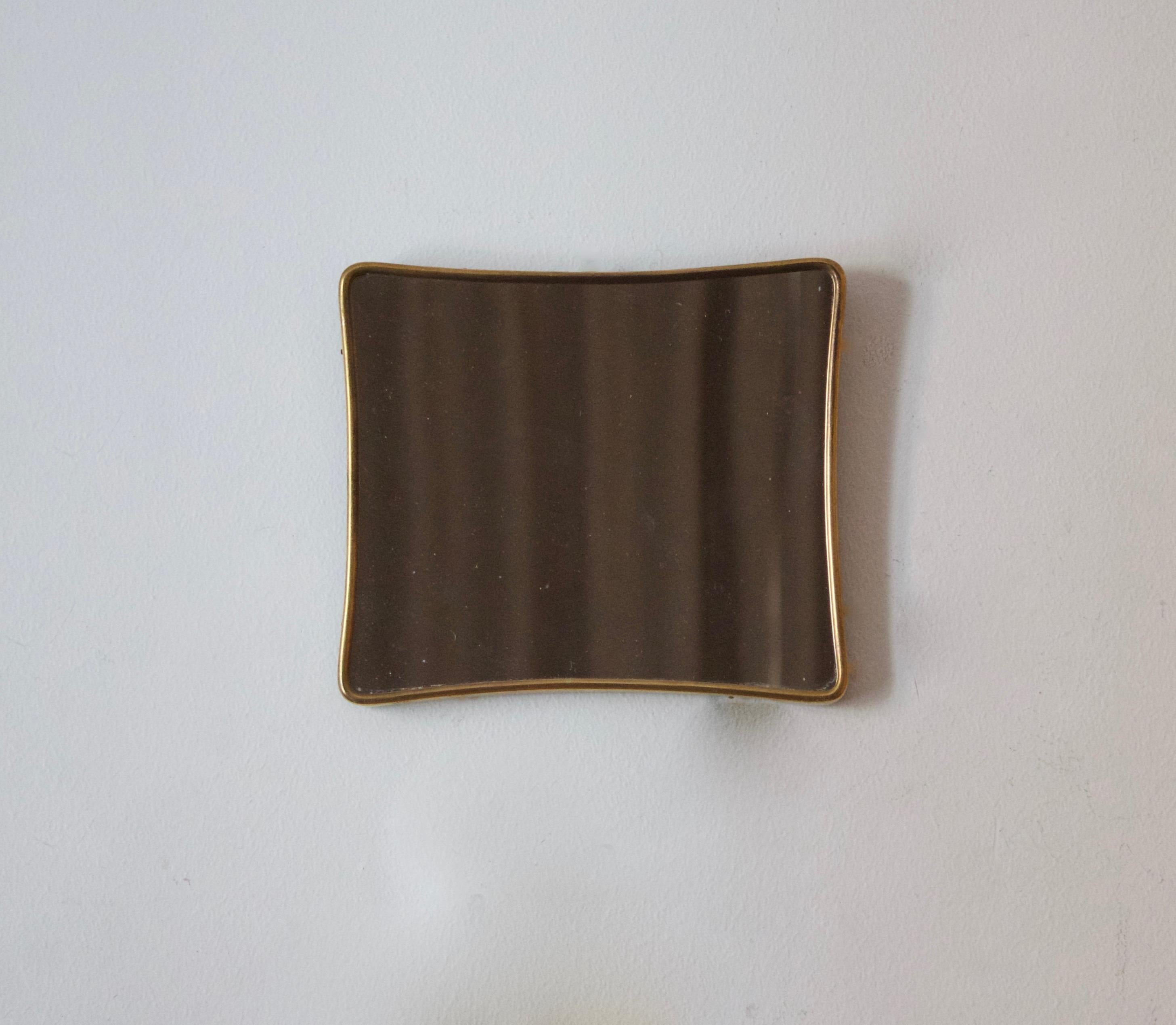 A very small wall mirror, produced in Italy, 1960s. Cut mirror glass is framed in brass frame.

Other designers of the period include Gio Ponti, Fontana Arte, Paolo Buffa, Franco Albini, and Jean Royere.