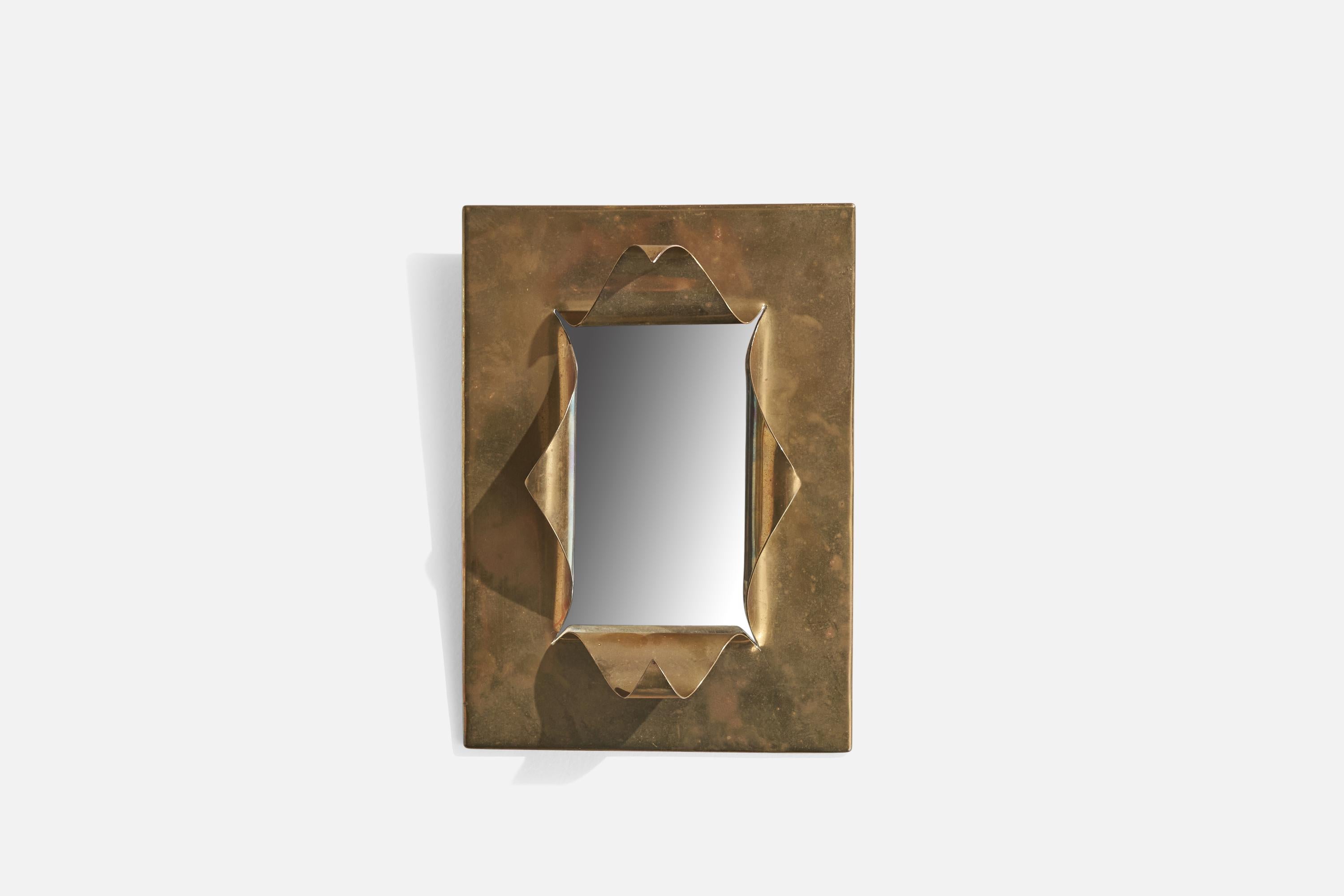 A sculptural brass mirror designed and produced in Italy, 1930s.