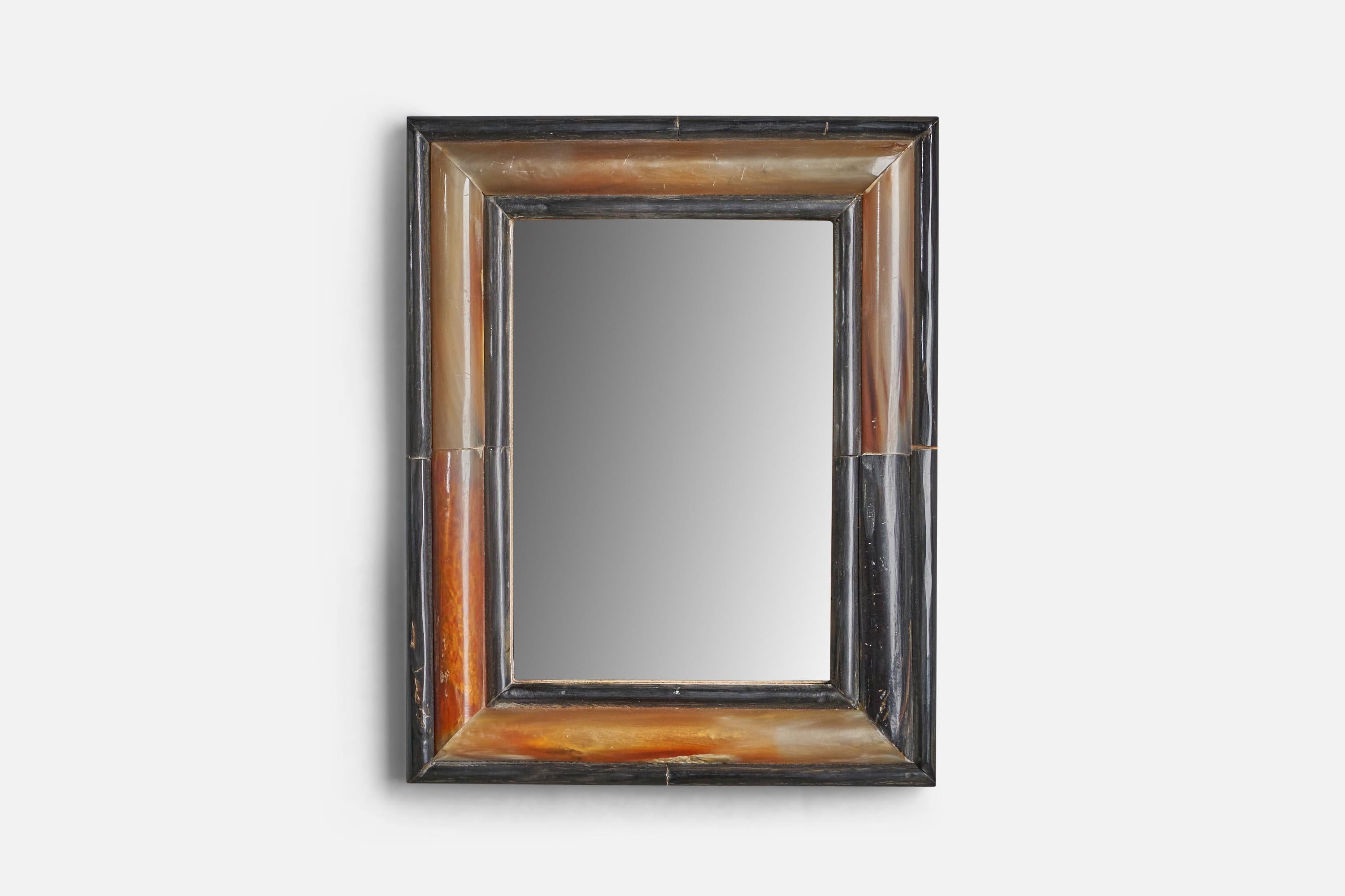 A brown and black carved horn wall or table mirror, designed and produced in Italy, c. 1930s.

With mountings for either wall or table top. 