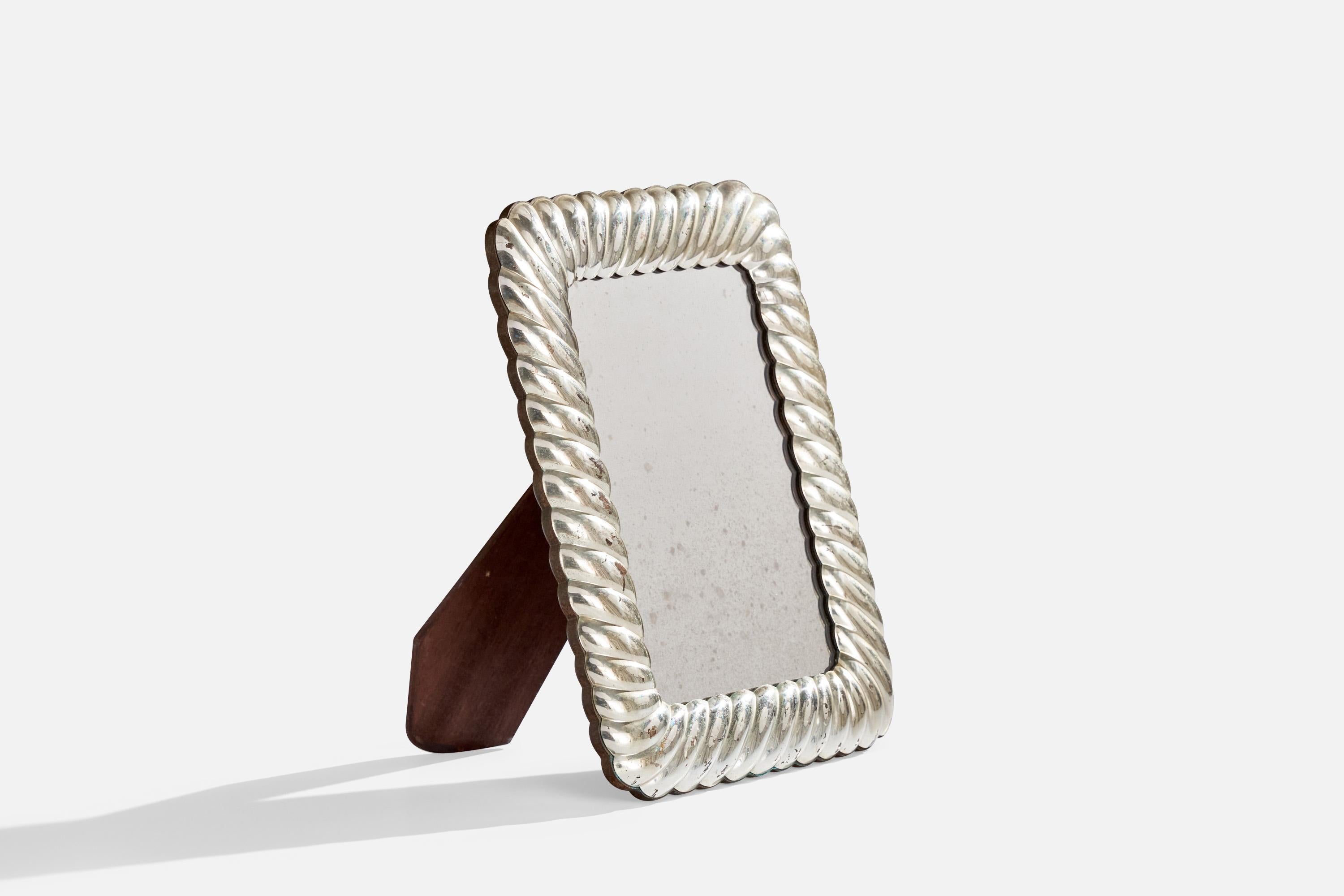 A small sterling silver wall mirror designed and produced in Italy, c. 1960s.
With mountings for either wall or table top.