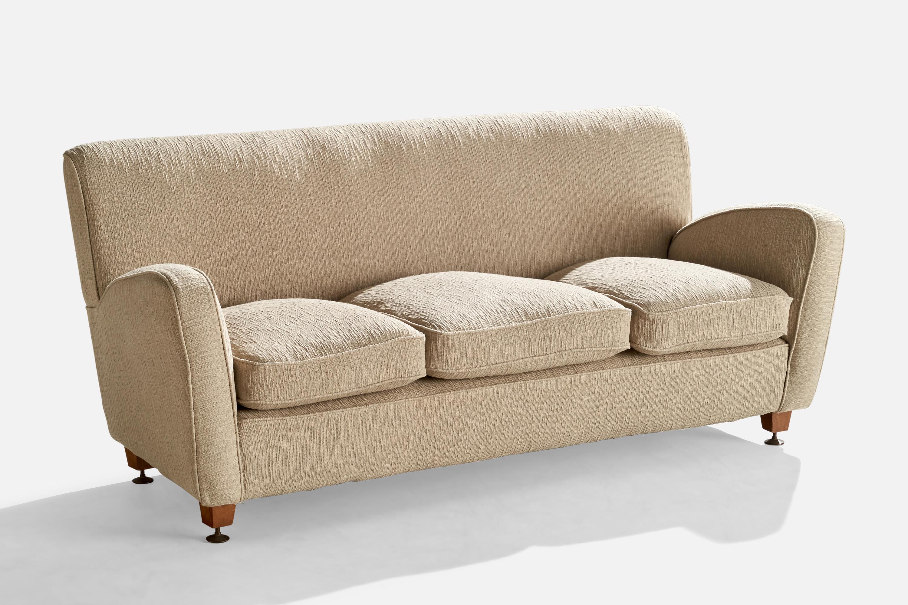 A beige fabric, wood and brass sofa designed and produced in Italy, c. 1940s.

Seat height: 19.5”
Arm height: 25.25”
