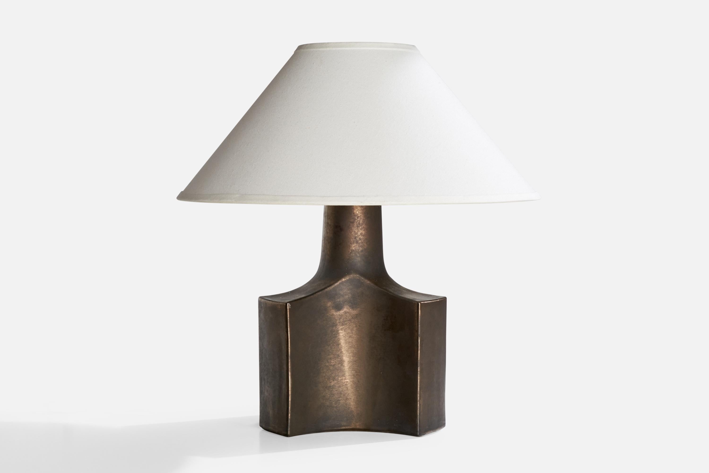 A large patinated brass table lamp designed and produced in Italy, c. 1970s.

Dimensions of Lamp (inches): 17.5” H x 11.5“ W x 10.5” D

Dimensions of Shade (inches): 7” Top Diameter x 22” Bottom Diameter x 12” H

Dimensions of Lamp with Shade